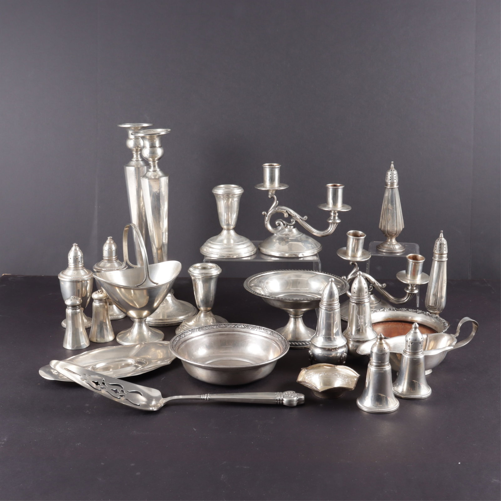 Group of Sterling Silver Tableware: Group of Sterling Silver Tableware.Weighable sterling includes small gravy boat with underplate, handled basket, set of salt & pepper shakers, and two bowls.Together with three pairs of weighted candl