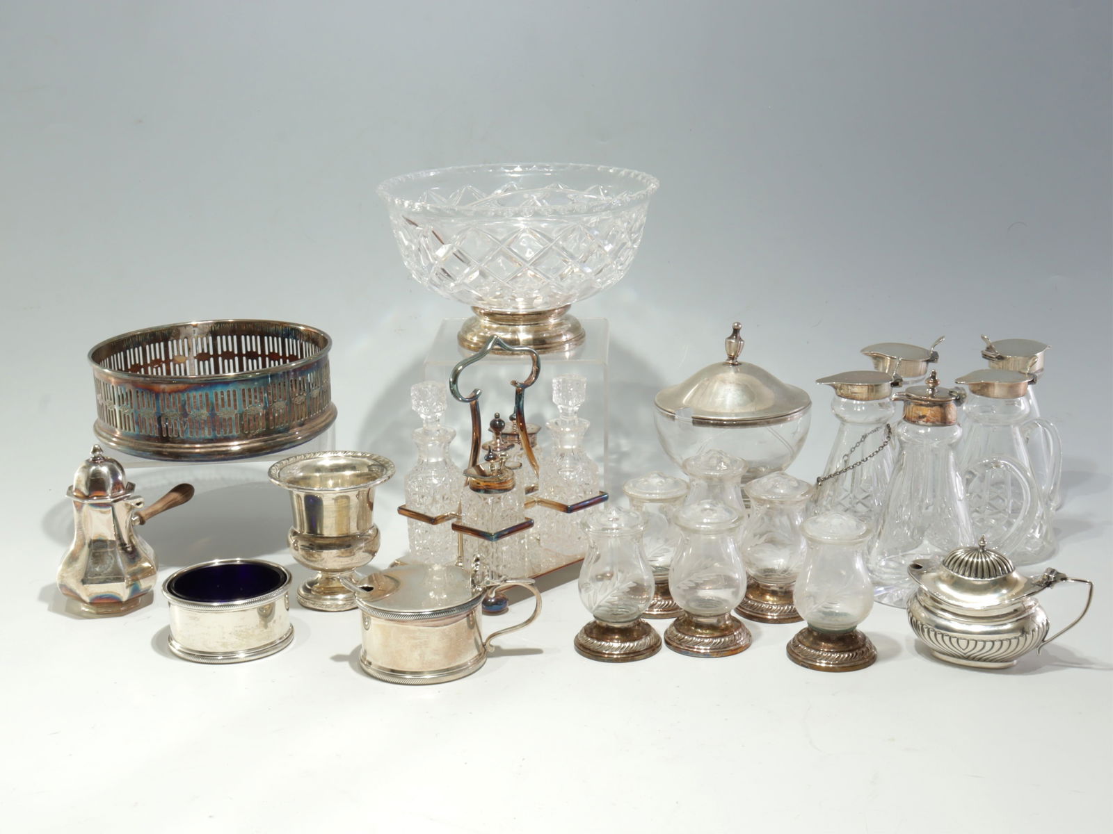 Sterling Silver Condiment Tableware: Edward Barnard & Sons salt cellar and mustard pot,1950 with mustard pot, 1952 with associated spoon, a lidded pouring vessel signed G Vavassori, glass lined mustard pot marked V A Birmingham along wit