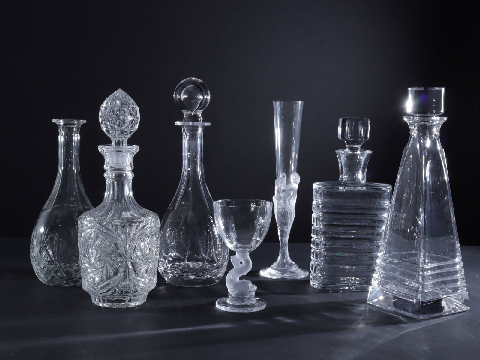 Tiffany Wright & Bruneau Decanters, Others: Group of 5 crystal/glass decanters includes one Tiffany & Co, Frank Lloyd Wright design, one Brunau, 2 pressed glass unsigned, one Atlantis of Portugal oval, one Romain de Tirtoff Erte flute vase and