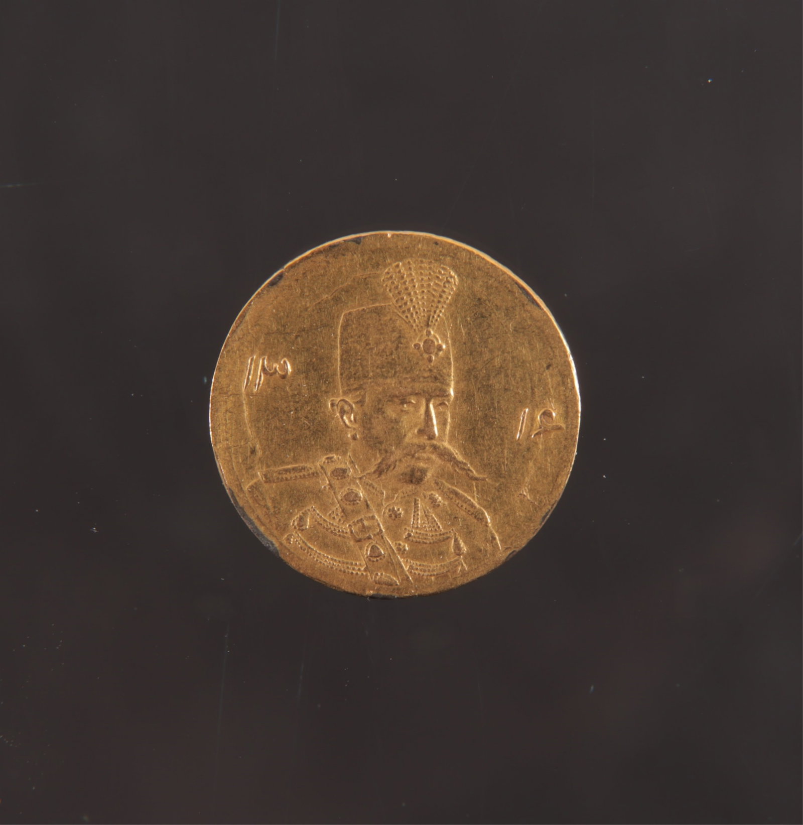 1906 Qajar Dynasty 1/2 Tuman Gold Coin: 1324 (1906) Iran, 1/2 Tuman gold coin depicting Mozaffar ad-Din Shah. 1.4 grams 16.9 mm