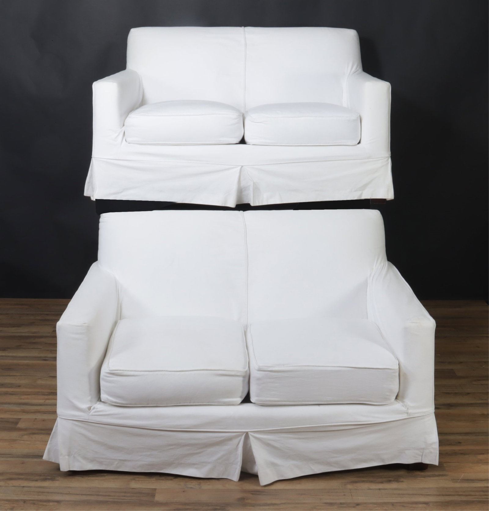 Pair of Ralph Lauren Upholstered Love Seats: Pair of Ralph Lauren Upholstered Love Seats, upholstered in white cotton 33" H x 56" W x 39" D From a private Long Island collection