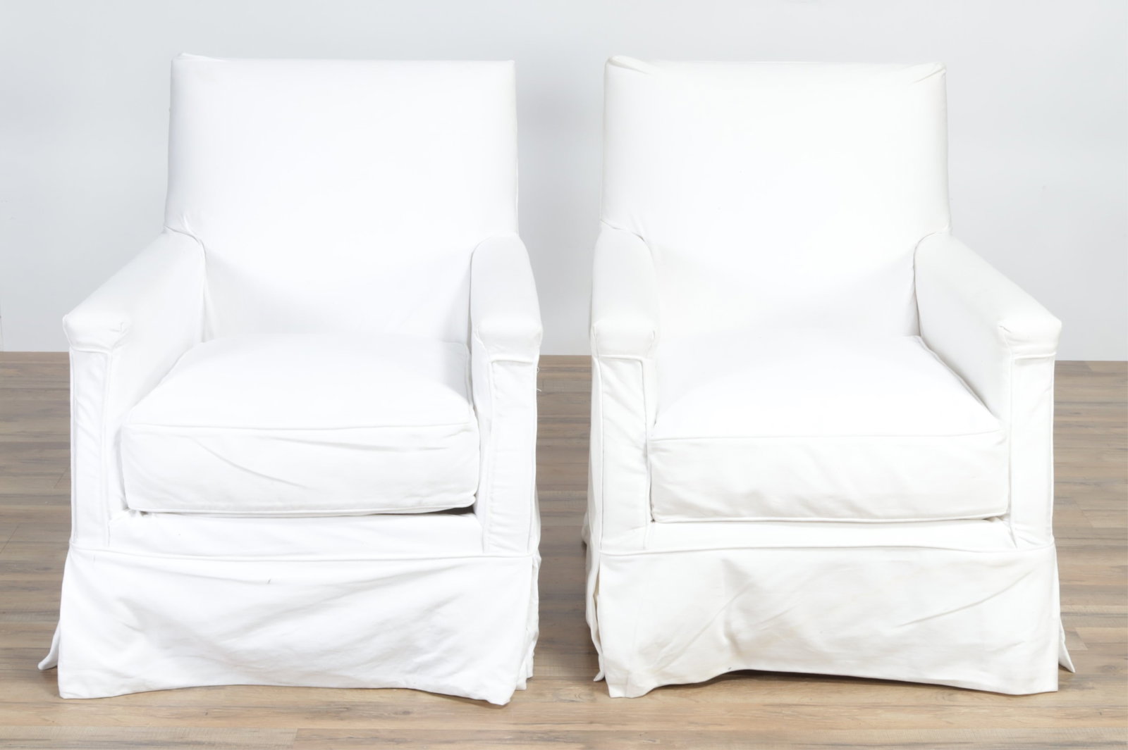 Pair Contemporary Upholstered Club Chairs: Pair Contemporary Upholstered Club Chairs, upholstered in white cotton 23" H x 27.5" W x 33" D From a private Long Island collection