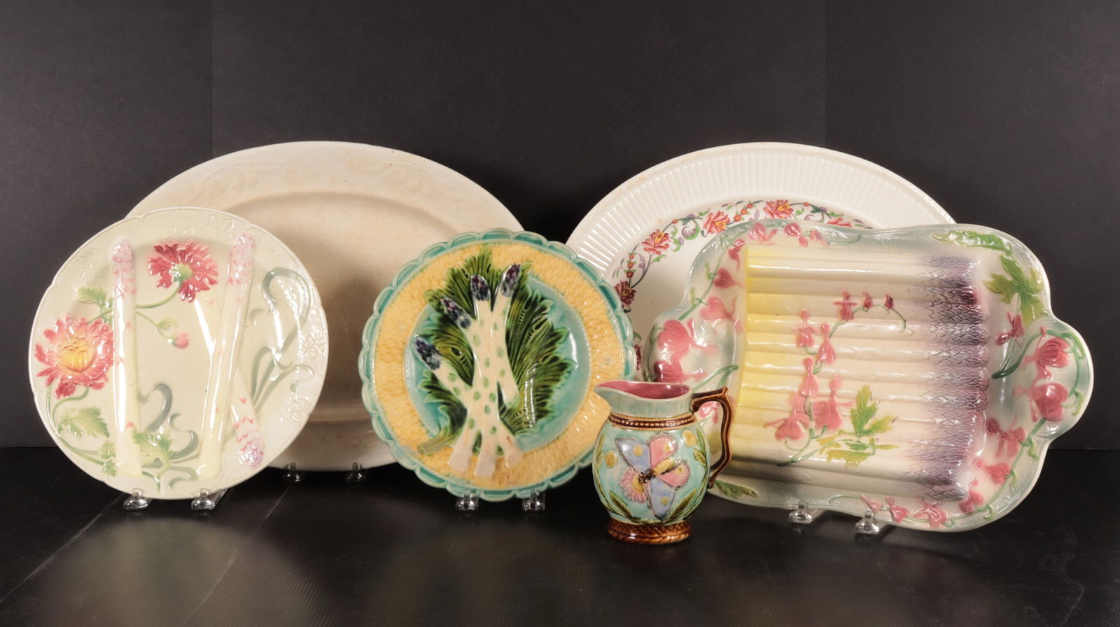 French Majolica & Stoneware Serving Pieces: Collection of French Majolica serving pieces, L.19th - E. 20th C. comprised of a Belgian Mouzin Lecat Butterfly and Flower pitcher, St. Clement Bleeding Heart Asparagus serving dish, attributed round