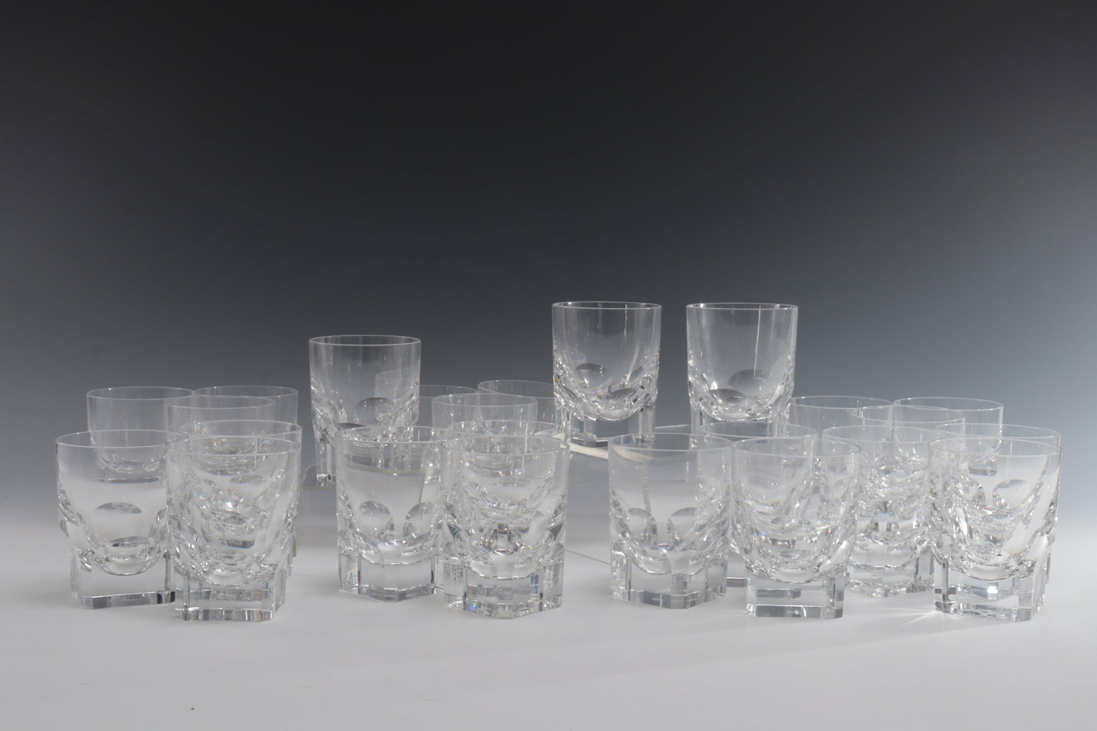 Baccarat Crystal Pluton Tumblers: Baccarat "Pluton" Tumblers / Old Fashion glasses. Set of 27. 3 additional not photo'd 4.25" H 3.25" Dia Rim 2.25" Sq base Property from a renowned fashion executive, Washington, CT.
