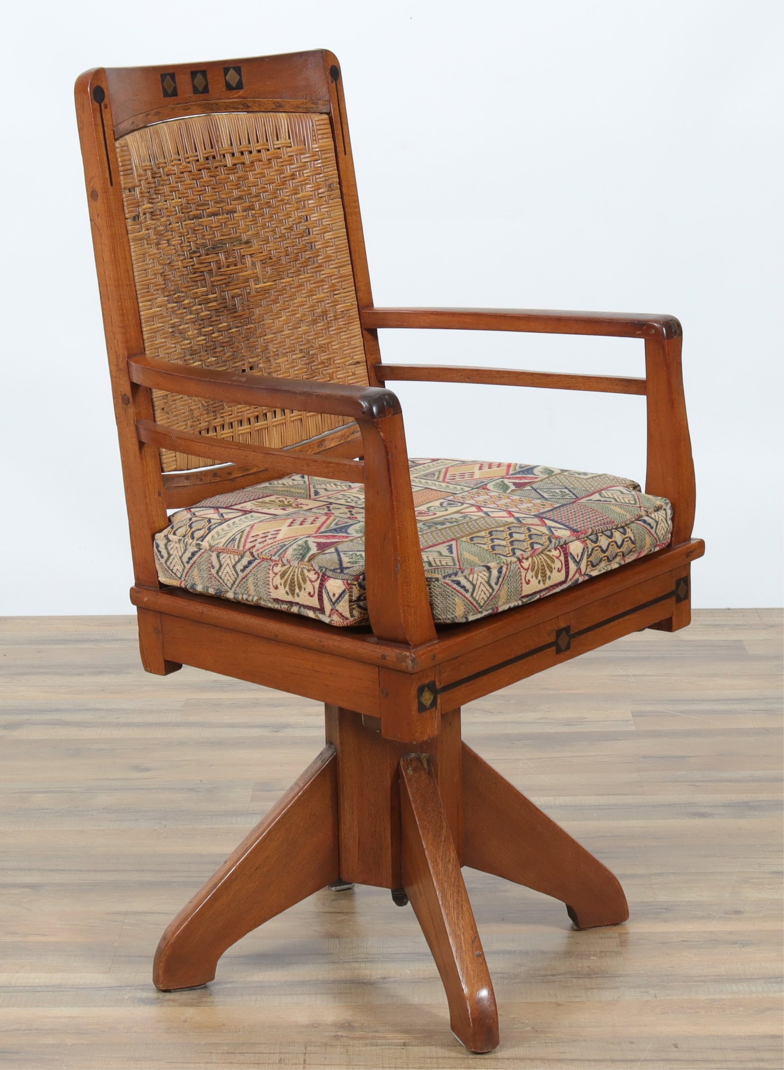 Arts & Crafts Inlaid Teak Swivel Desk Chair: Arts & Crafts Inlaid Teak Swivel Desk Chair, Early 20th C., upholstered in geometric brocade Dimensions: 41" H x 22.75" W x 21" D From a Manhattan Residence