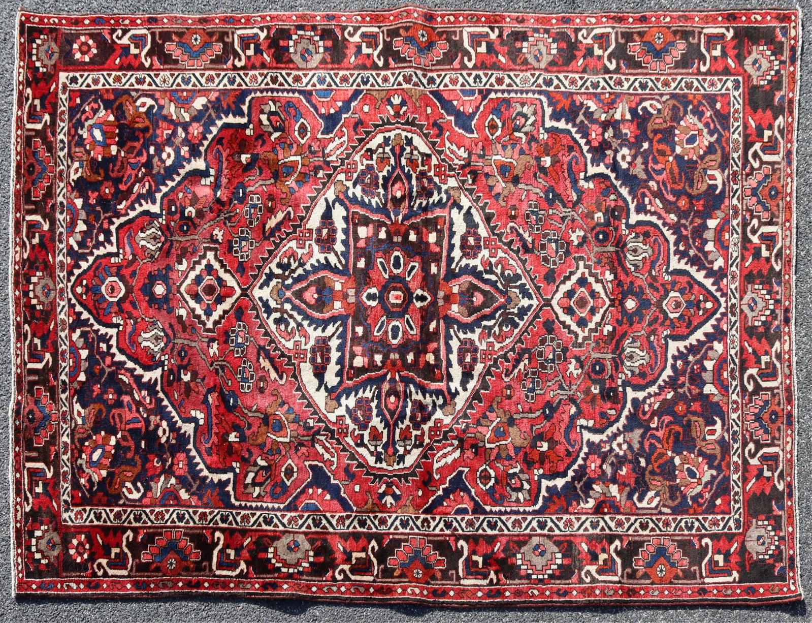 Turkish Wool Rug 7 x 9-9: Turkish wool rug, 20th C., red, off white, dark blue grounds geometric figures throughout Dimensions: 7 x 9-9