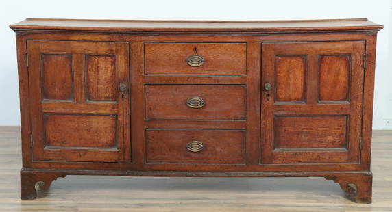 Welsh Oak Dresser Base, 19th C.: Welsh Oak Dresser Base, 19th C., paneled case with scrolling bracket feet 35.25" H x 71.25" W x 16.25" D Property from the estates of Thomas Johnson Hubbard and Anne Attfield Hubbard of Bronxville NY