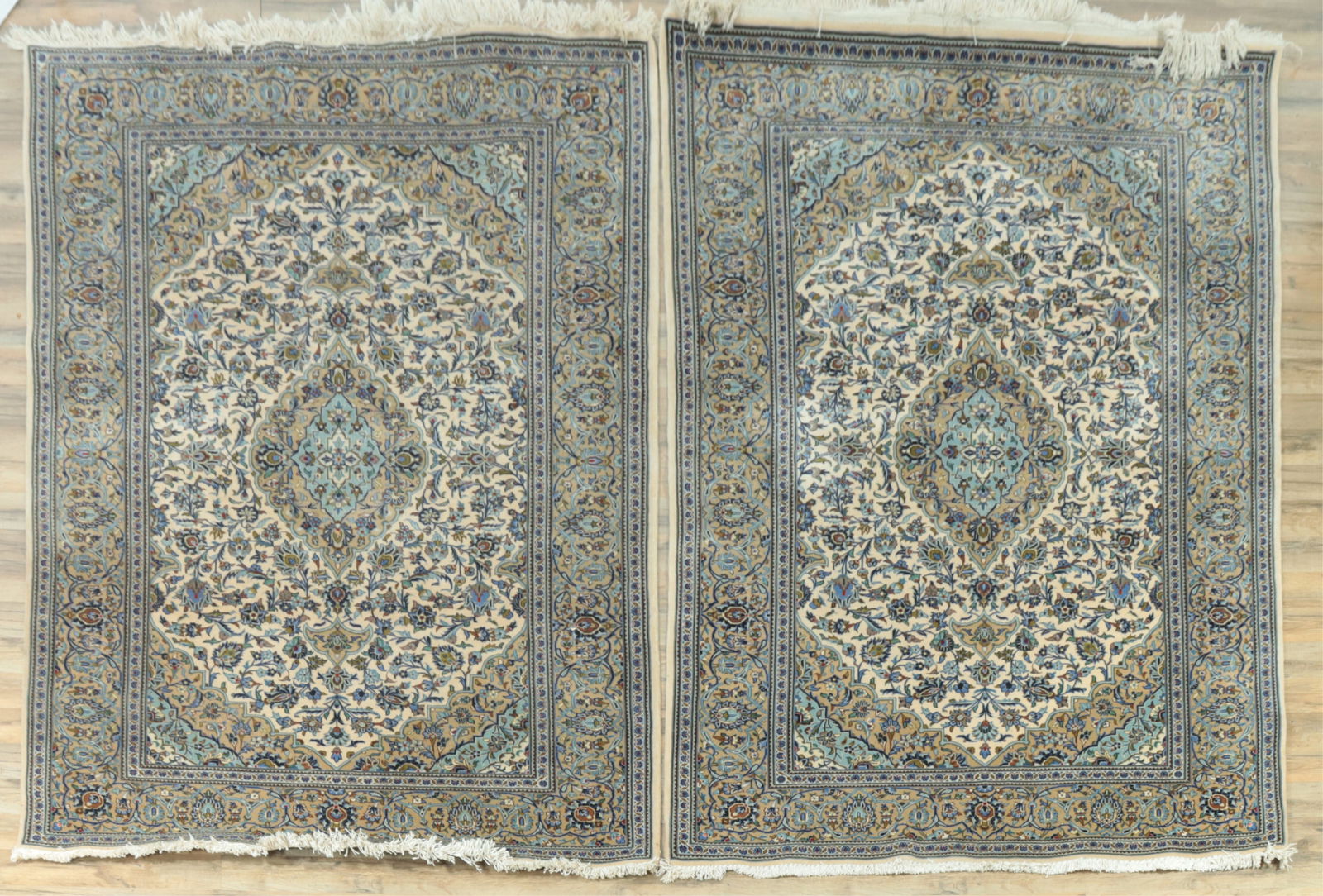 Pair of Kashan Carpets 7-3 x 4-7: Pair of Kashan wool carpets, ivory ground with blue and gold floral motifs, central medallion and for quadrants with matching ground 7' 3" x 4' 7" Property from the estates of Thomas Johnson Hubbard a
