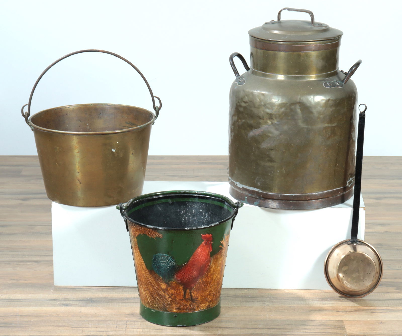 Brass Milk Can, Bucket, Ladle: Can/churn with well fitted lid; copper handles, neck and base rims; punched in design to top of lid handle. Remnants of stamped in mark on bottom. Bail handled bucket. Brass ladle pan with black paint