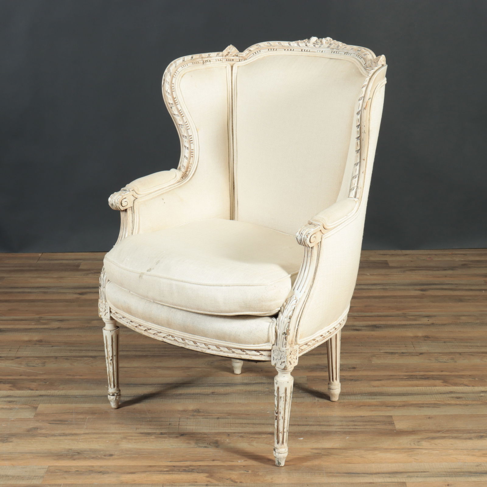 Louis XV Style White Painted Bergere: Louis XV Style White Painted Bergere, upholstered in off-white fabric 40.25" H x 26.25" W x 27.5" D Property from a Northwest Connecticut collection.