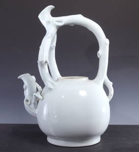 Large Celadon Porcelain Pitcher: Large porcelain pitcher in pale green celadon glaze, route work and branch motif for the spout and the handle. No marks. 21.5" tall Property from a Washington Connecticut Art Collector