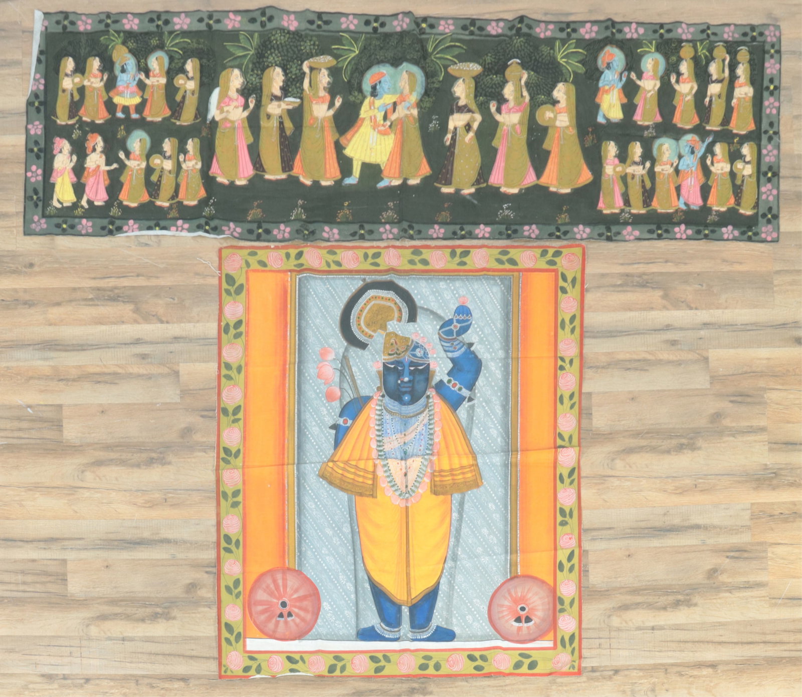 Two Indian Pichwai Paintings on Fabric: Two Indian Pichwai paintings of pigment on fabric. A vertical oriented one featuring Krishna Shrinathji and a horizontal one depicting Scenes of Lord Krishna and the Gopis in the garden. 35.25" W X 42