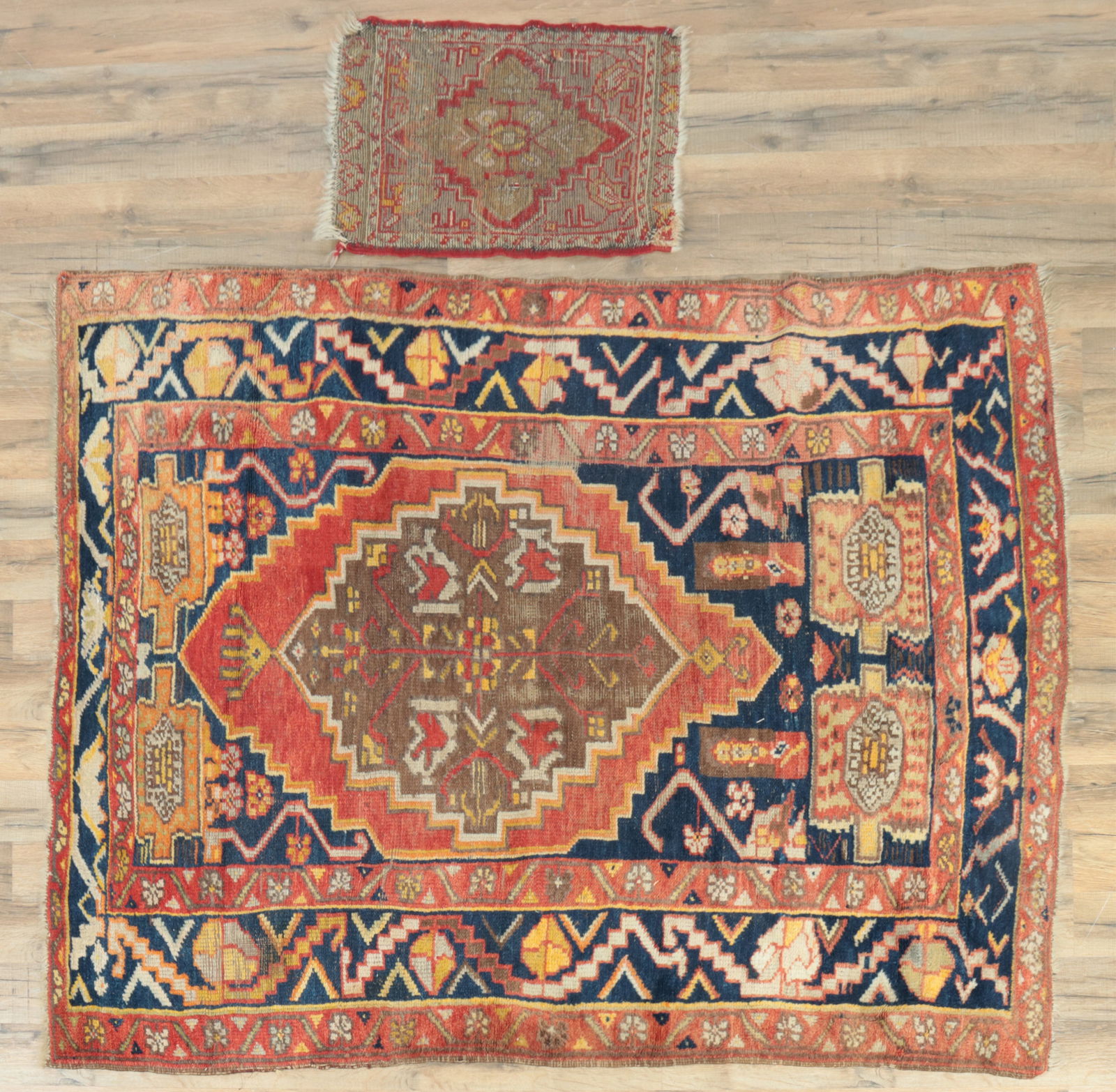 Two Caucasian Carpets 14 x 22, 4-2 x 5-5: Two Caucasian hand knotted wool carpets, one scatter rug with Heriz pattern, tan/gold ground with rust another with large center geometric medallion of tan and rust color, alternating dark blue and ru