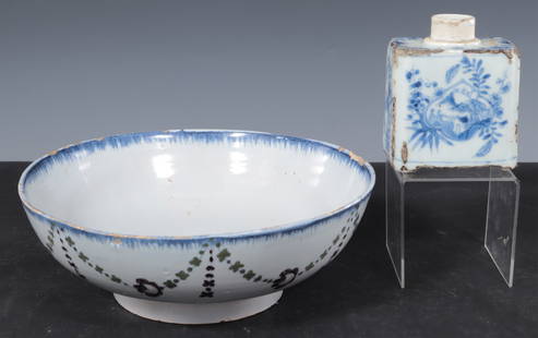 Delft Pottery Bowl and Caddy: Comprising: one Delft pottery bowl with swag decoration to the outside and stylized floral decoration inside, blue and white rim; together with a blue and white caddy with landscape decoration Bowl: 3