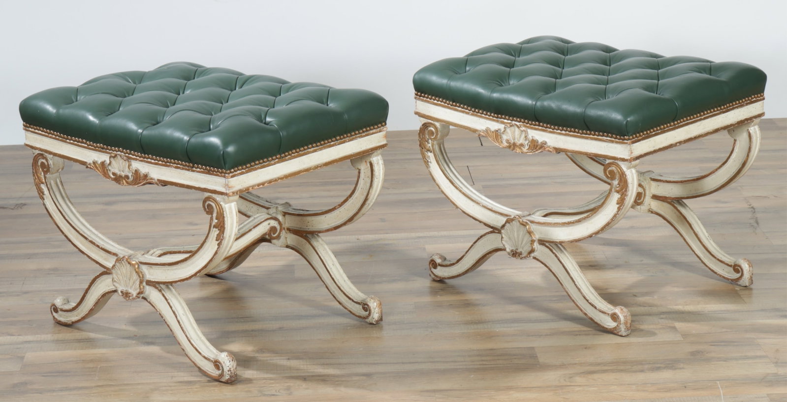 Pair of Louis XVI Style Curule Benches: Pair of Louis XVI Style Curule Benches. Cream painted, upholstered in green leather. 19" H x 24" W x 18" D Property from the Estate of Lola Finkelstein