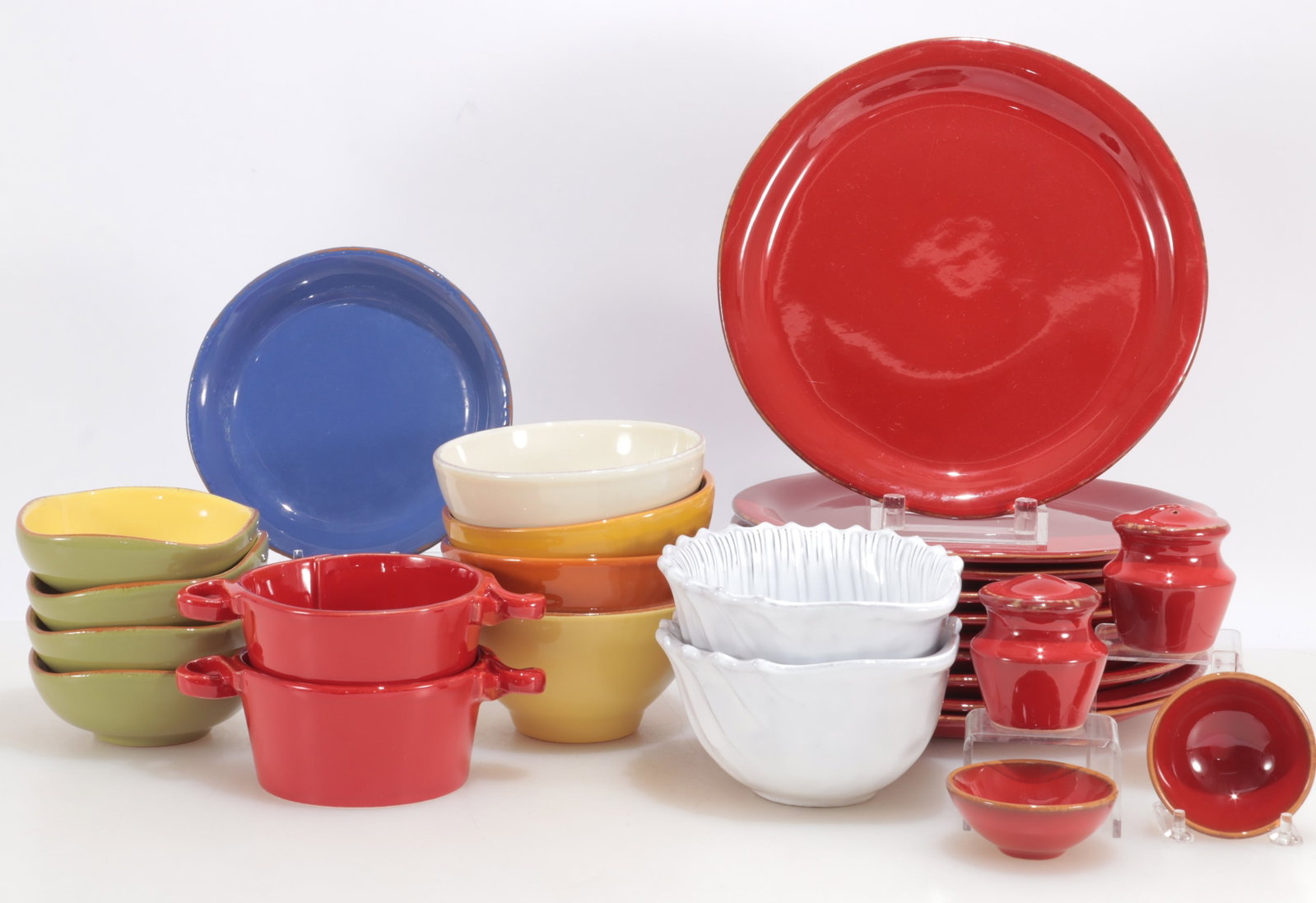 Vietri Colored Dishware: Group of variously colored Vietri dishware, Italian, 20th Century, comprising: 10 red plates (11" dia); 4 bowls (3 1/4" H x 6" dia); 4 square bowls (2" H x 5" W x 5" D); 2 double-handled red bowls (2 