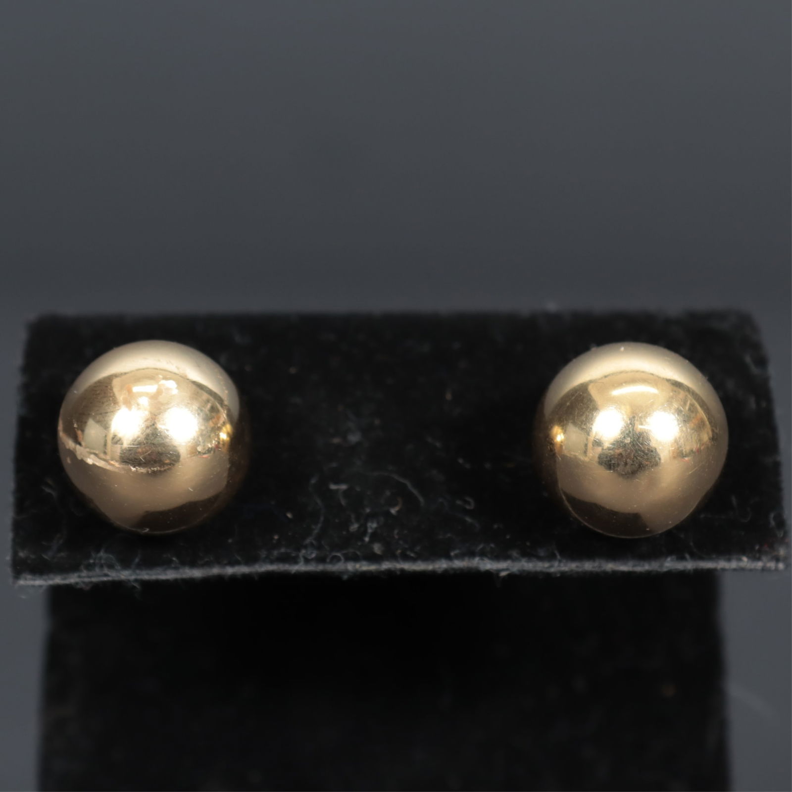 Pair of 14K Yellow Gold Sphere Earrings: A pair of vintage 14k yellow gold hollow spherical post earrings, measuring approximately 13mm., 3.0 grams. 13 mm diameter. Property from the estate of Mary C. Bailey.