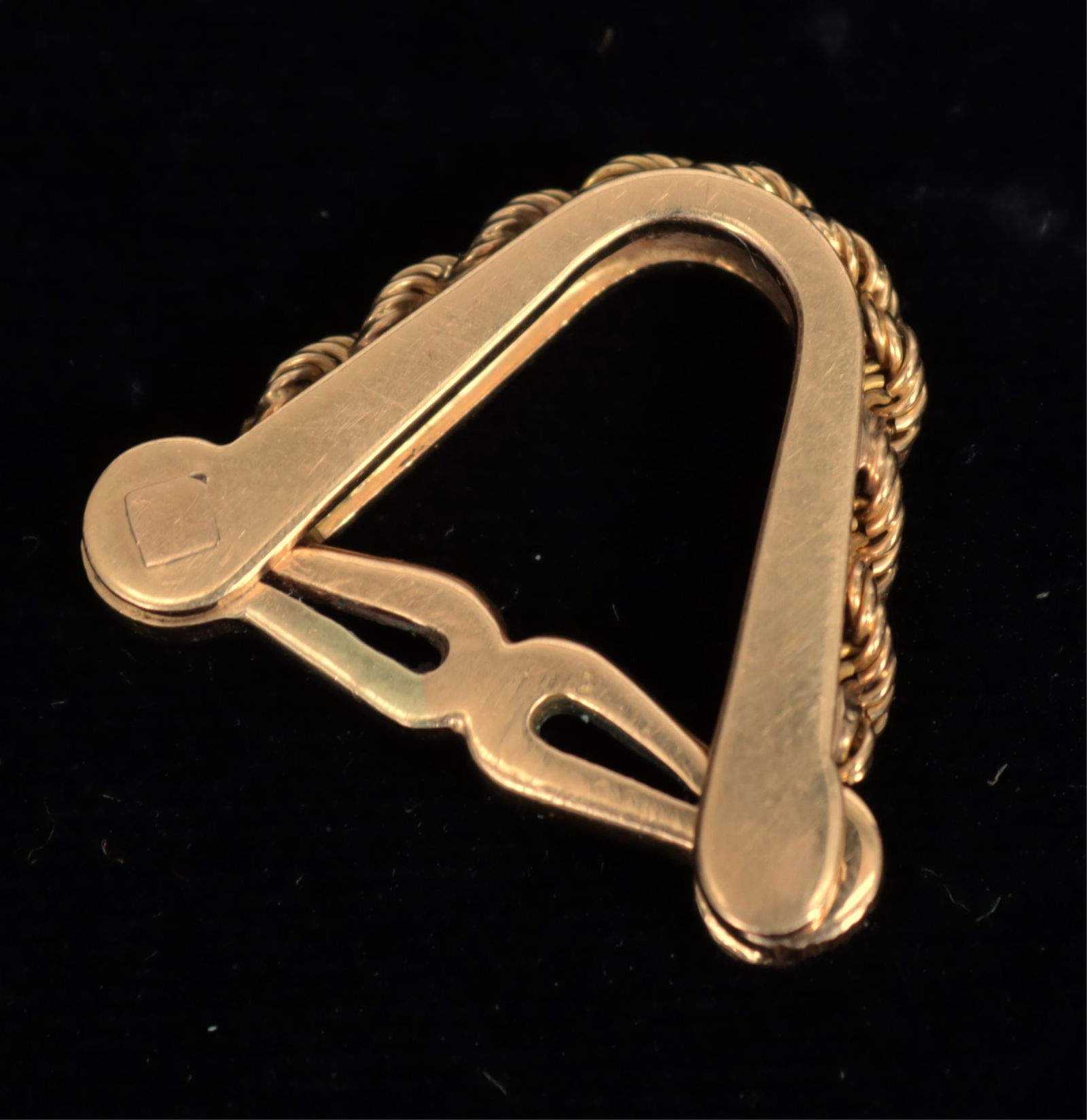 French 18K Yellow Gold Stirrup Cufflink: A single French 18k yellow gold stirrup cufflink with rope twist chain adornment. Stamped with two eagle heads and NE maker's mark. 6.4 grams. 1" W x 0.75" H Property from a northwest Connecticut coll
