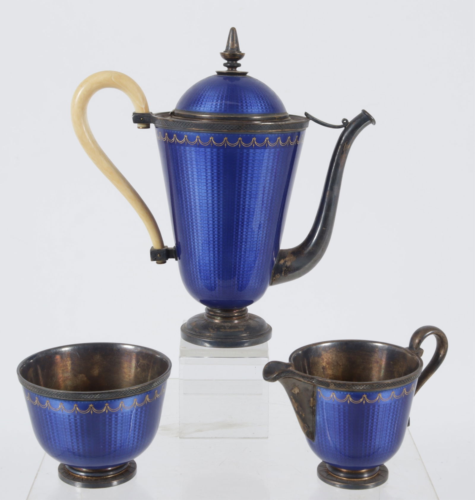 David Andersen Blue Enamel Sterling Silver Tea Set: David Andersen (1843-1901) cobalt blue enamel over sterling silver tea set with vermeil interiors, bone handle. Gross weight: 23 OZT. Teapot 7" H Property from a Connecticut shoreline collection.