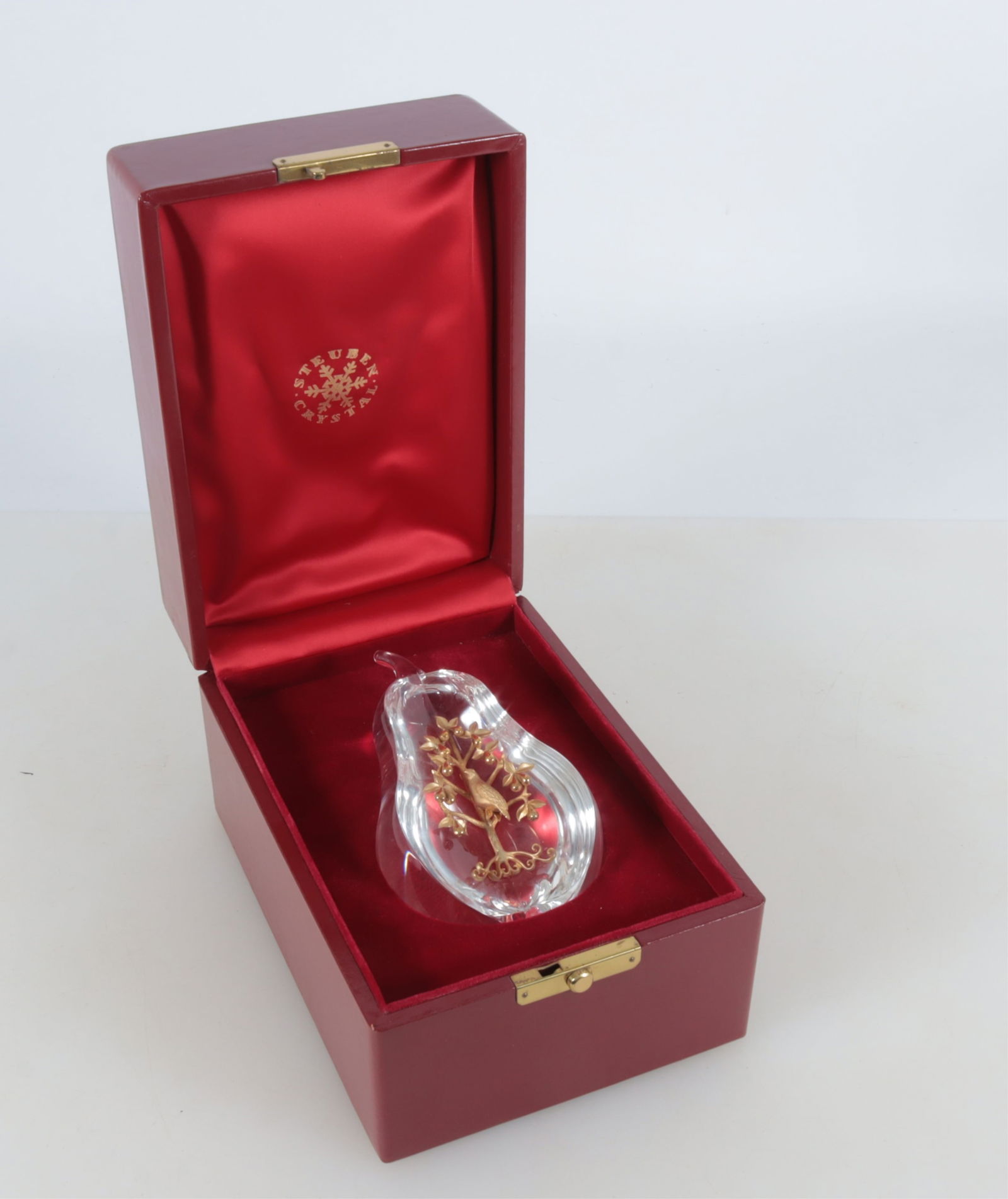 Steuben "Partridge in a Pear Tree": Lloyd Atkins for Steuben, "Partridge in a Pear Tree", cut open crystal pear with 18k yellow gold inset tree. 6" H Property from the estate of Mary Bundy.