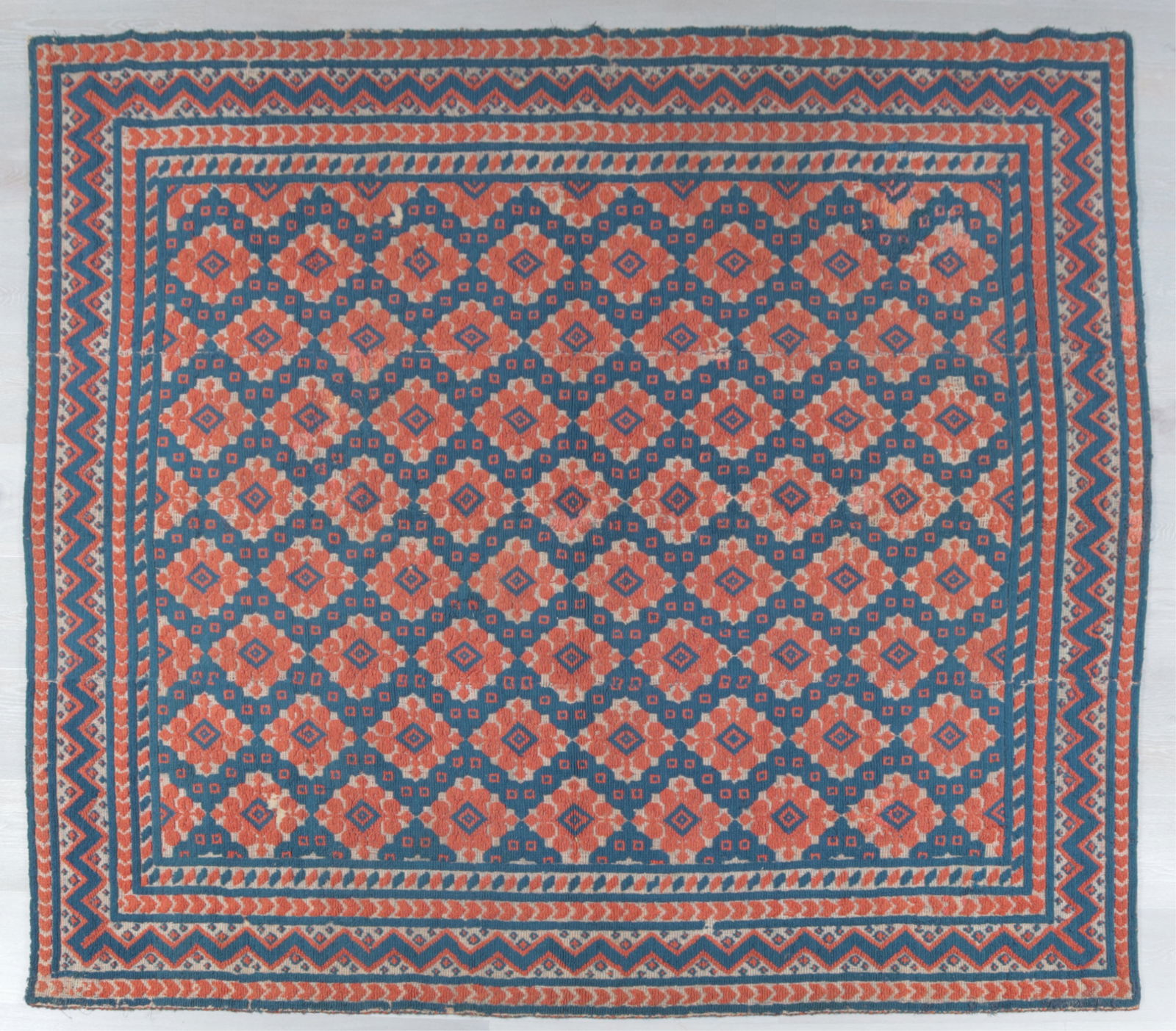 Dhurrie Flatweave Textile: Dhurrie flatweave textile, late 19th Century, with a linen backing, navy and dark orange in geometric patterns.Dimensions: 75 3/4" H x 93 3/4" WProperty from the Estate of Isobel & Price Glover, Litch