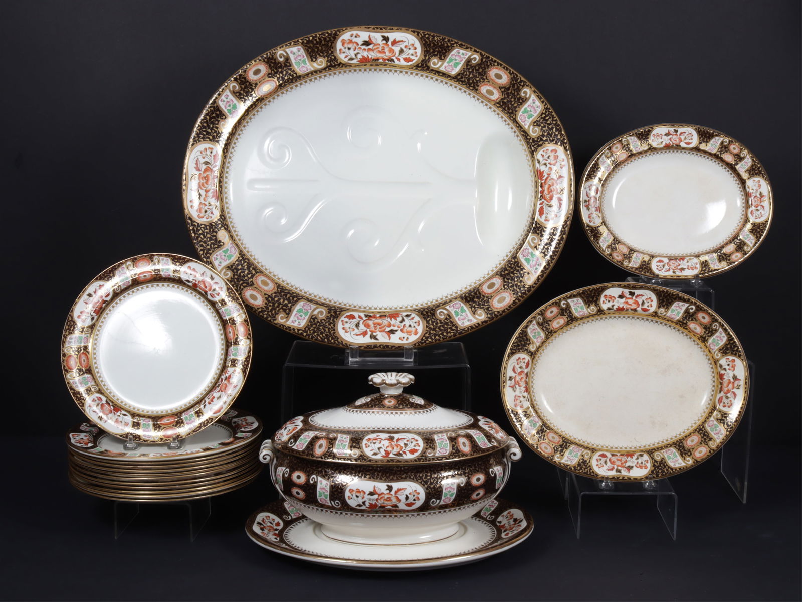 Group of Wedgwood Black Imari Porcelain: Wedgwood, England, Black Imari partial dinner service comprising: 12 dinner plates, tureen, three serving trays, and platter.Dimensions: Platter 21.25" wide