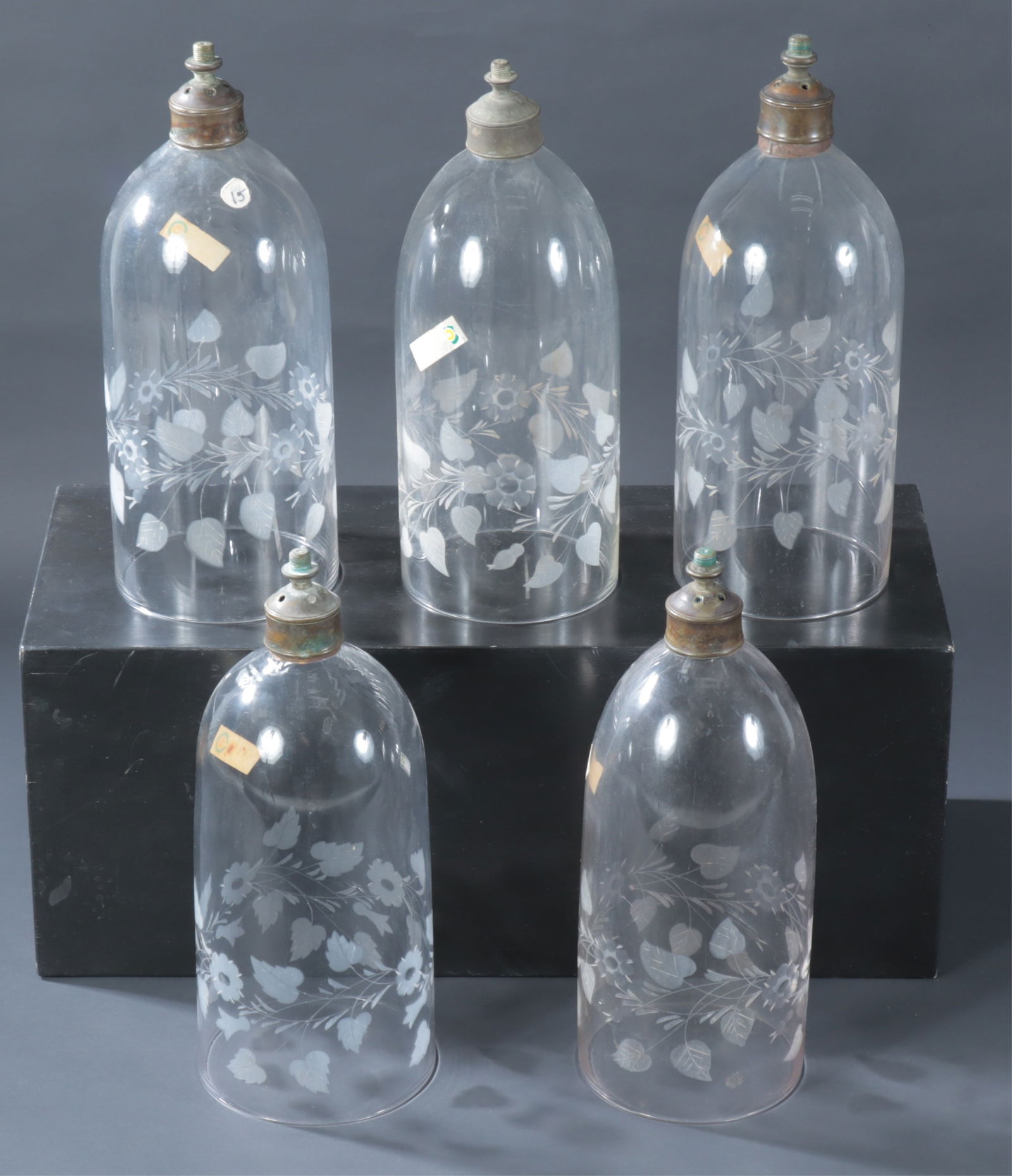 Five Etched Glass Hurricane Shades: Five Etched Glass Hurricane Shades, with brown threaded nozzlesDimensions: 15.5" HProperty from the Estate of Isobel & Price Glover, Litchfield, CT.