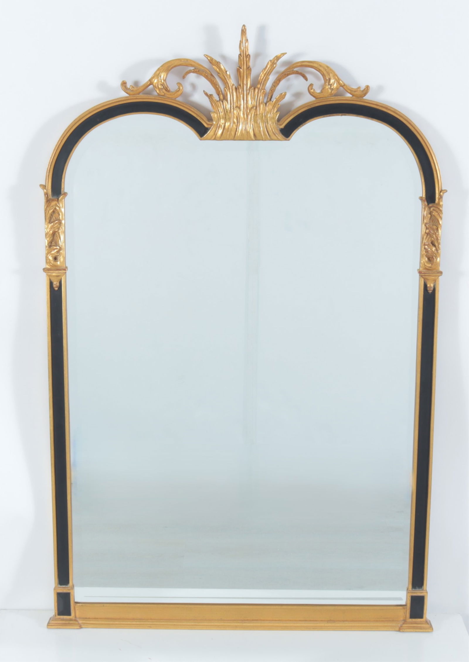 Baroque Style Carver's Guild Pier Mirror: Baroque style parcel gilt and ebonized pier mirror, made by Carver's Guild, with beveled mirror plateDimensions: 44 3/4" H x 29 1/4" WProperty from the Estate of Mary C. Bailey