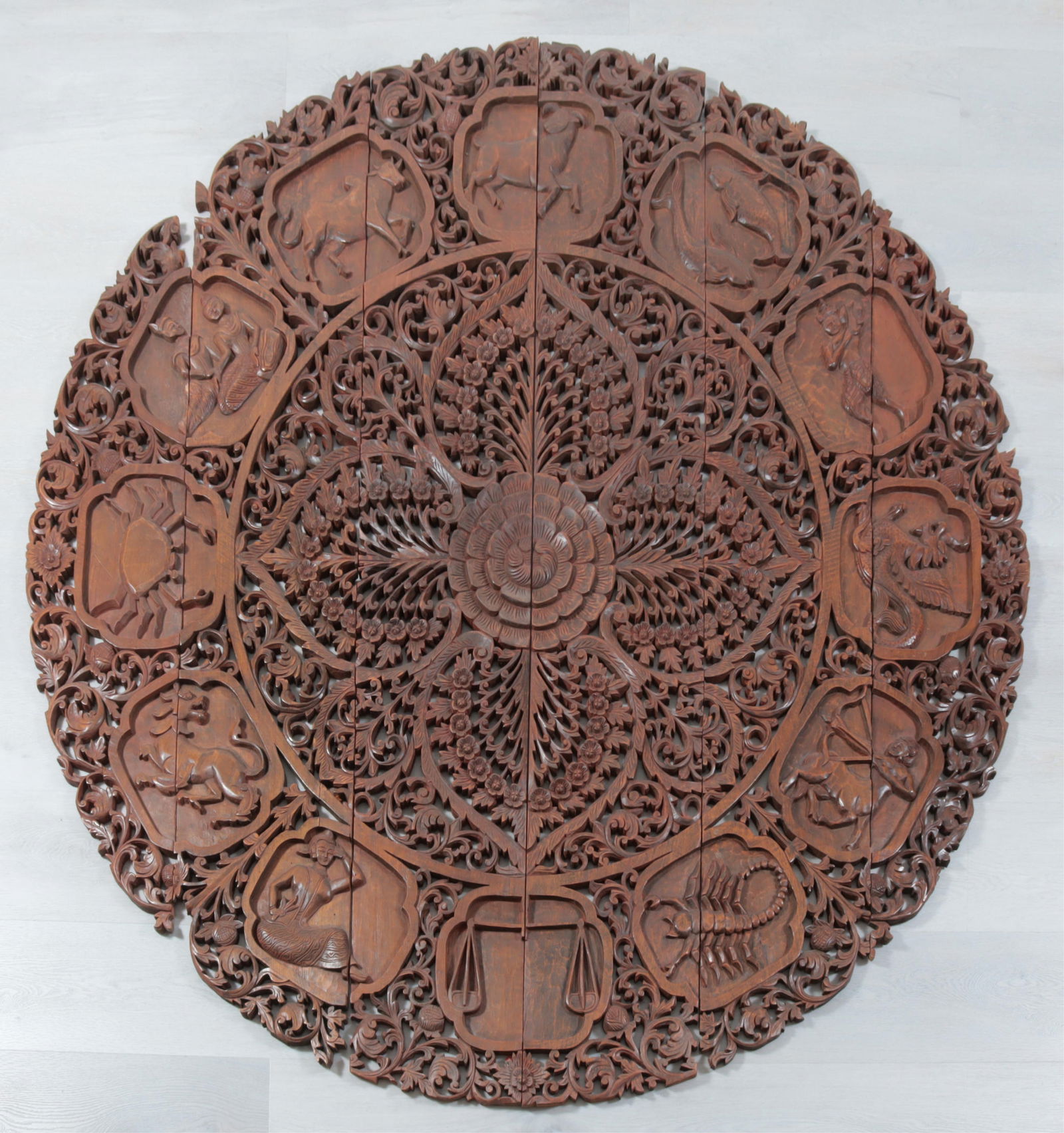 Southeast Asian Teakwood Zodiac Roundel: Southeast Asian style carved teakwood zodiac roundel, with pierced and carved relief with 12 symbols, in 6 panels.Dimensions: Approximately 71" H x 69 1/2" W
