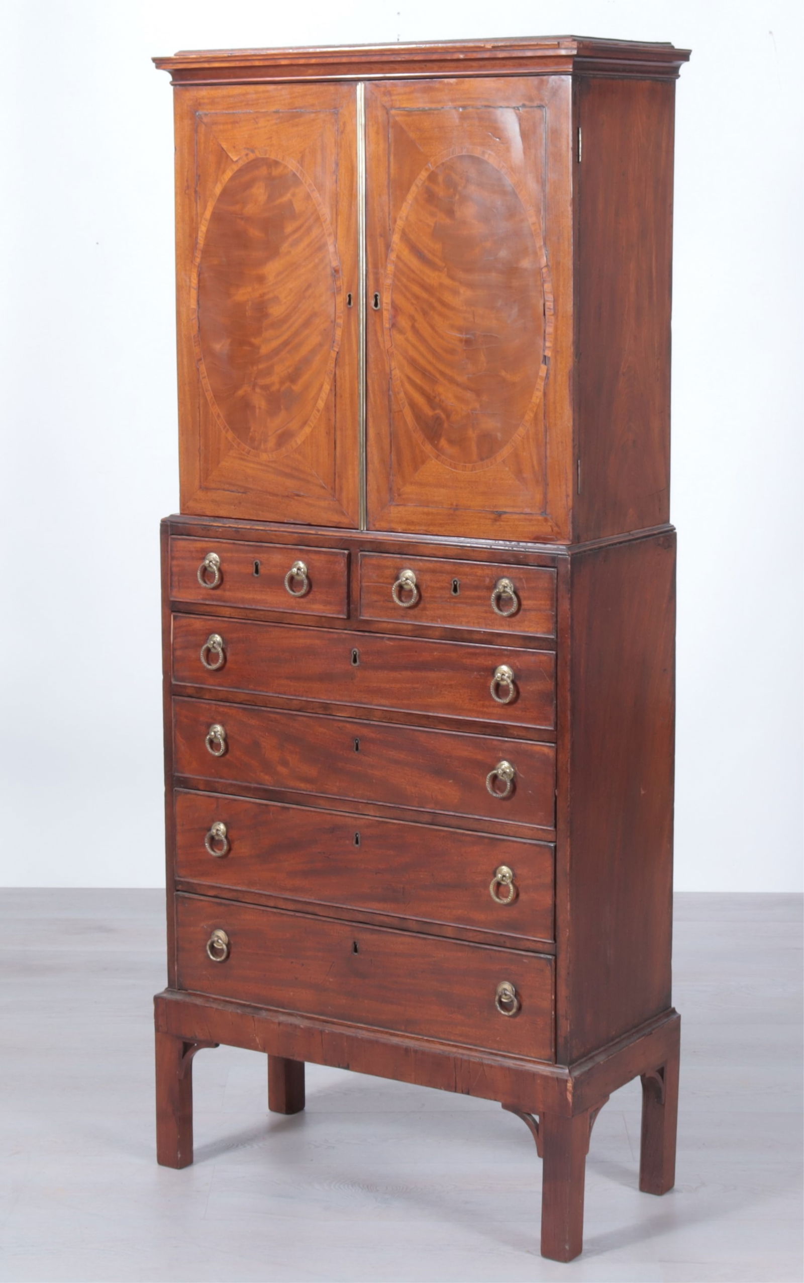 George III Inlaid Mahogany Cabinet on Chest 18th C: George III Inlaid Mahogany Cabinet on Chest, 18th C. Two doors enclosing four shelves with 24 segments, over six drawers.Dimensions: 62.5" H x 26.5" W x 12" D