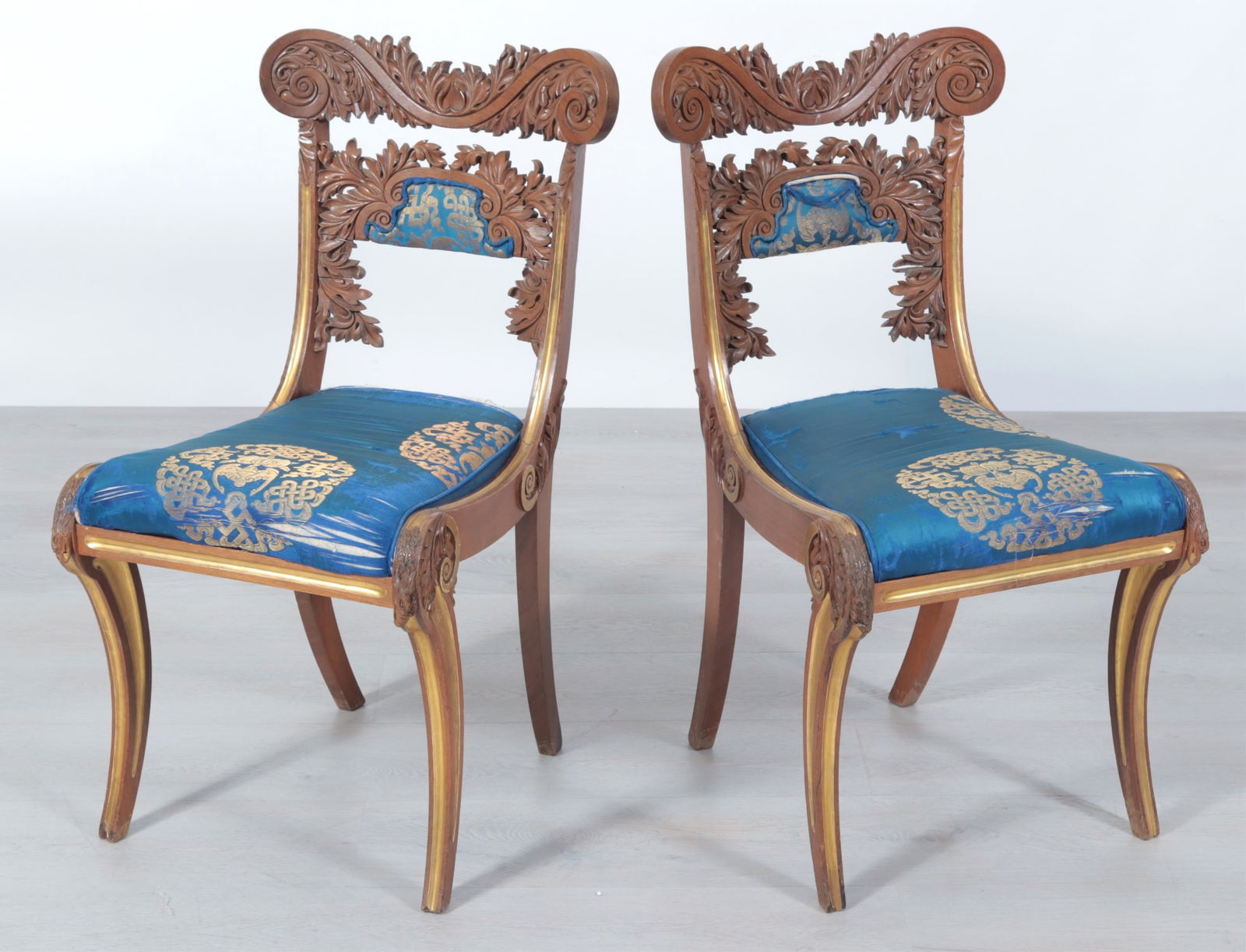 Pair Regency Parcel-Gilt Rosewood Side Chairs, 19C: Pair Regency Parcel-Gilt Rosewood Side Chairs, Early 19th C., in cobalt embroidered silk upholstery, inventory label AH4284, painted deaccession #WBM2519 and WBM25 BISDimensions: 34.5" H x 18.25" W x