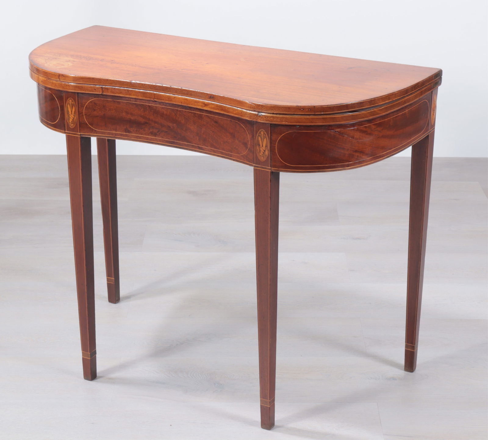 Federal Inlaid Mahogany Card Table: American Federal Inlaid Mahogany Kidney Form Card Table, early 19th Century, with shell and leaf inlay at the tops of each leg, single flyleaf.Dimensions: 29 3/4" H x 36 1/2" W x 17" D (closed) x 34 1