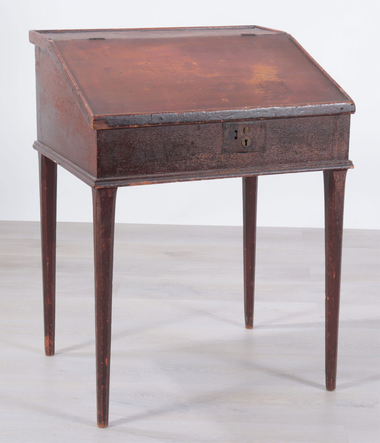 American Red Schoolmaster's Desk: American Red Stained Schoolmaster's Desk, 19th CenturyDimensions: 33 1/4" H x 24 3/4" W x 20 1/2" DProperty from the Estate of Isobel & Price Glover, Litchfield, CT.