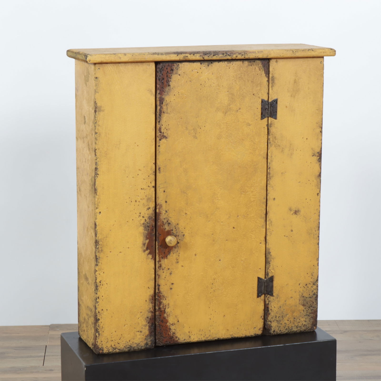 Diminutive Provincial Yellow Painted Cupboard: Diminutive Provincial style yellow-painted cupboard, made by Angel Woodworking, 20th Century, outset molded edged top, one drawer with wood pull and two butterfly hinges, shelved interior, back