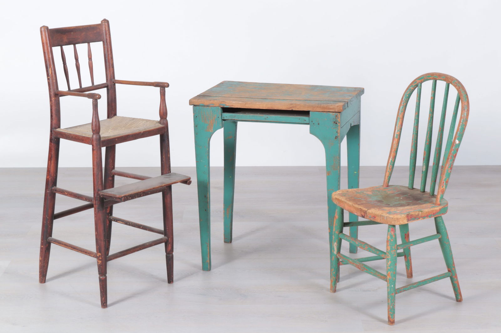Group Antique Children's Furniture: Group antique children's furniture, 19th/20th Century, comprising: a blue-green painted pine desk; a blue-green painted bow-back side chair; and a rush-seat high chair.Dimensions: Desk: 24 1/2"H x