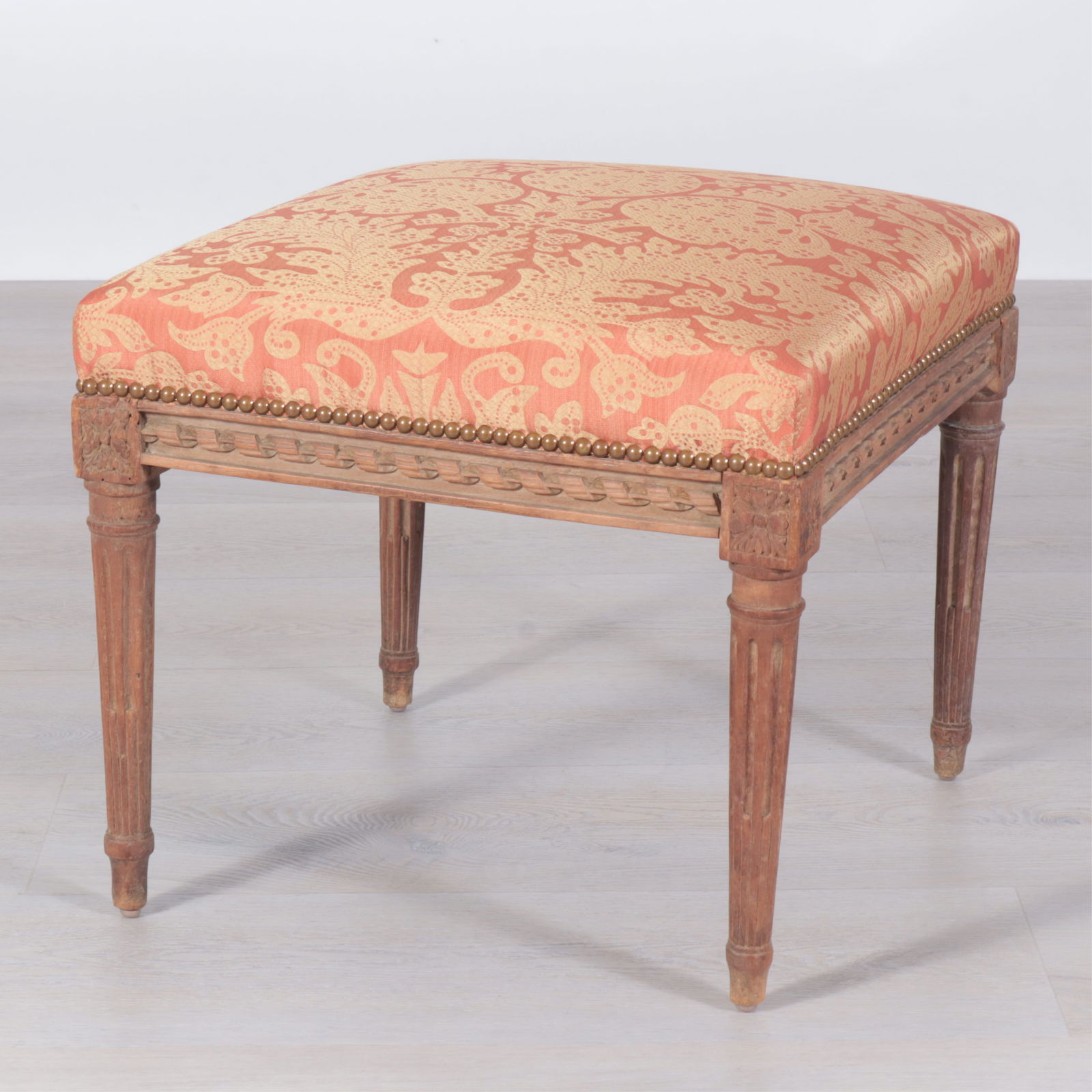 Louis XVI Style Beech Tabouret Stool: Louis XVI Style Beech Tabouret Stool, upholstered in gold and rust damask.Dimensions: 16.25" H x 17.5" Square