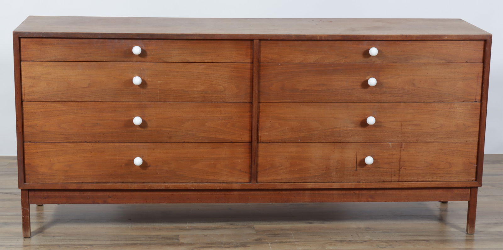 Paul McCobb Style 8-Drawer Dresser: Paul McCobb style 8-drawer dresser with white knobs.Dimensions: 31 3/4" H x 71" W x 17 3/4: DProperty from the estate of Nancy Lee Ryan, an accomplished documentary film narrator, actor, voice over
