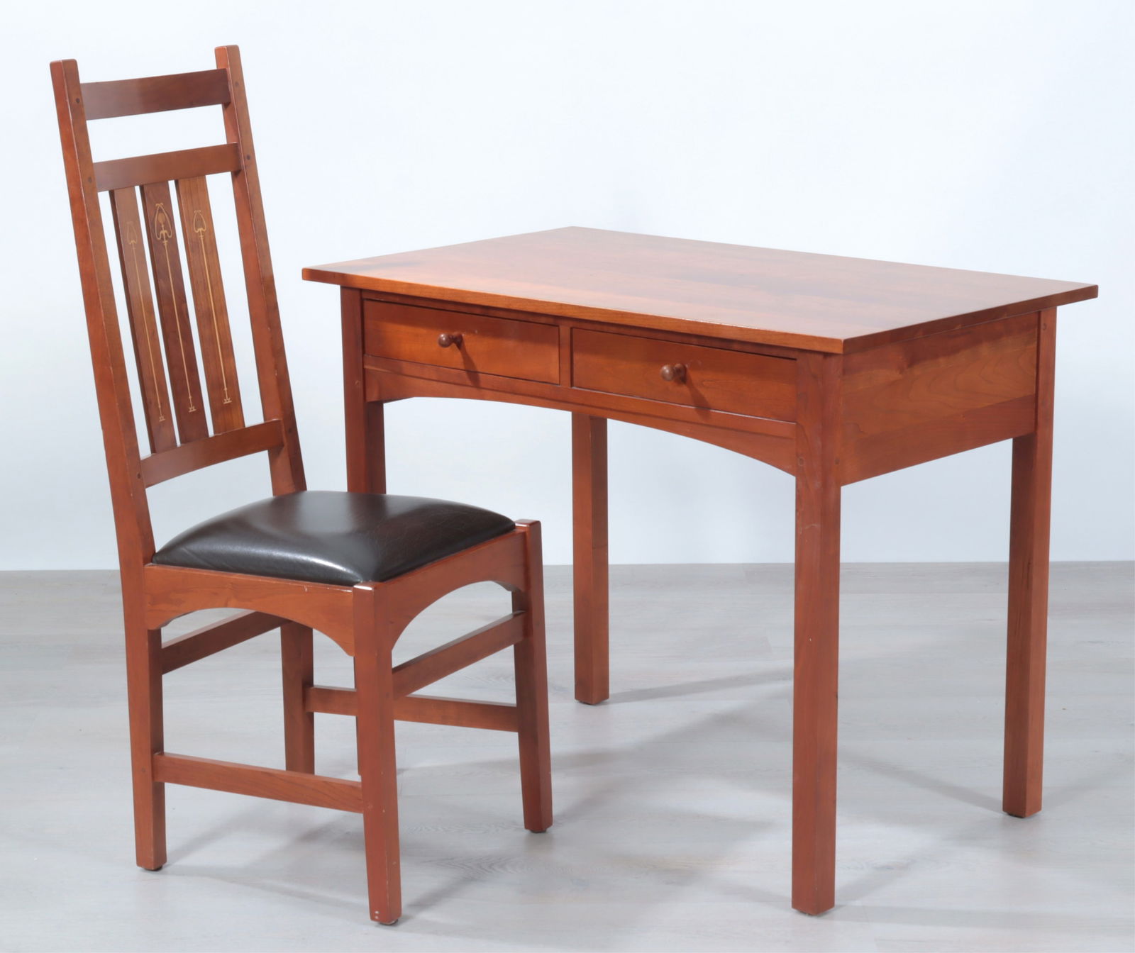 Stickley Cherry Desk & Harvey Ellis Chair: Stickley Cherry Desk & Harvey Ellis Chair, with stylized flower inlay, upholstered in black leatherDimensions: Desk 30" H x 38" W x 23" D, Chair 43" H x 16.75" W x 25" WProperty from the Estate of