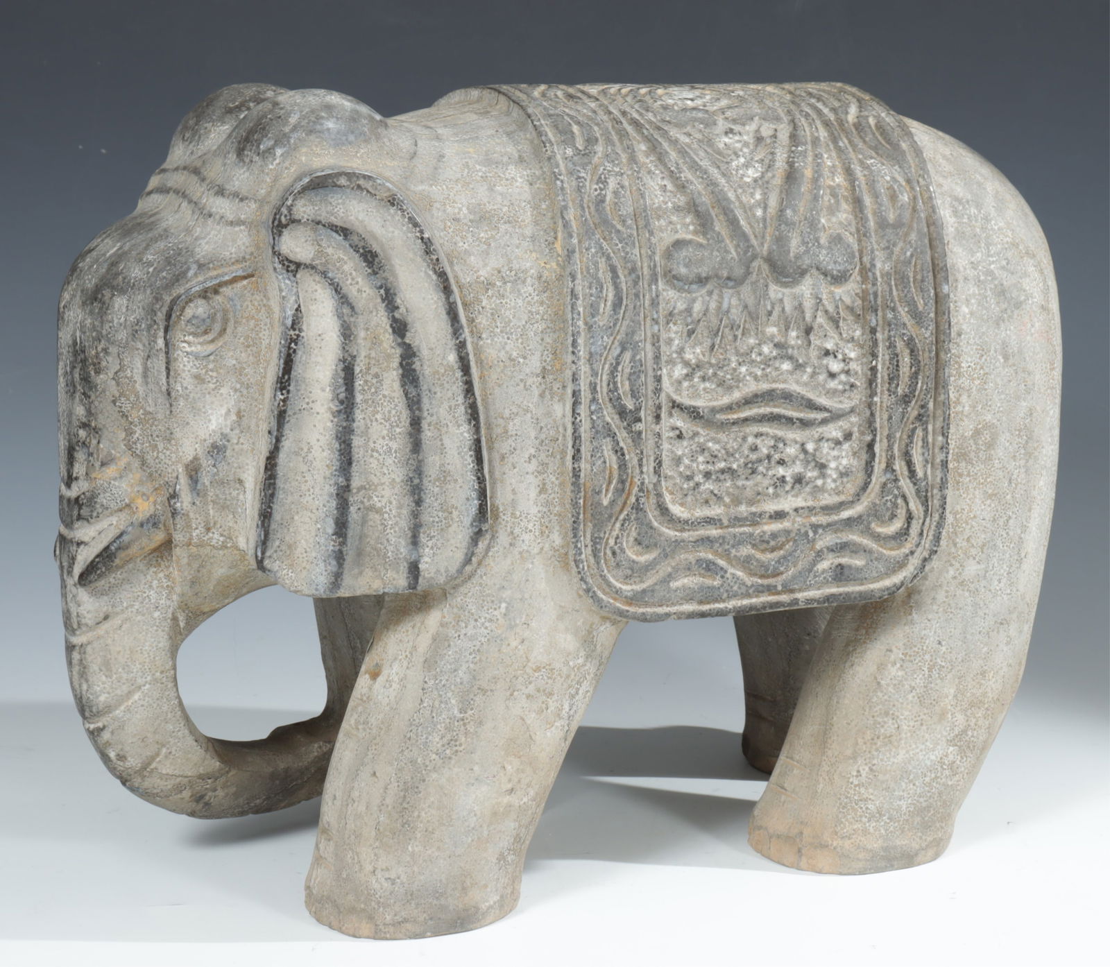 Indian Carved Grey Schist Elephant: Indian Carved Grey Schist Elephant, 20th C. Dimensions: 17" H x 7" W x 16.5" L. Weighing 70 lbs. 