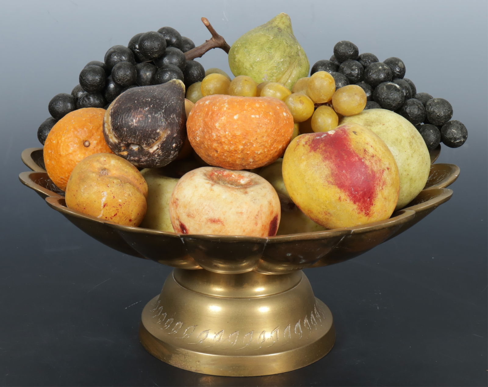 Group of Stone Fruit in French Brass Tazza: A grouping of hardstone and softstone fruits in a French brass chased tazza. Dimensions: Bowl 5.25" H 