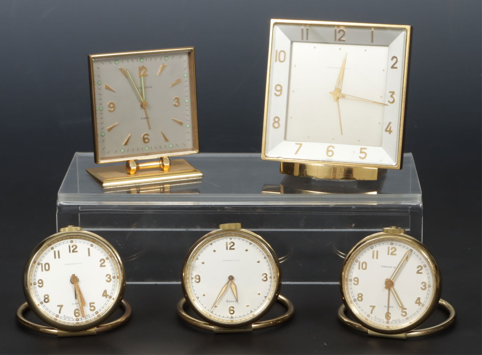 Group of Five Tiffany Brass Travel Clocks: Group of Five Tiffany Brass Travel Clocks Dimensions: Largest 4.25" H 
