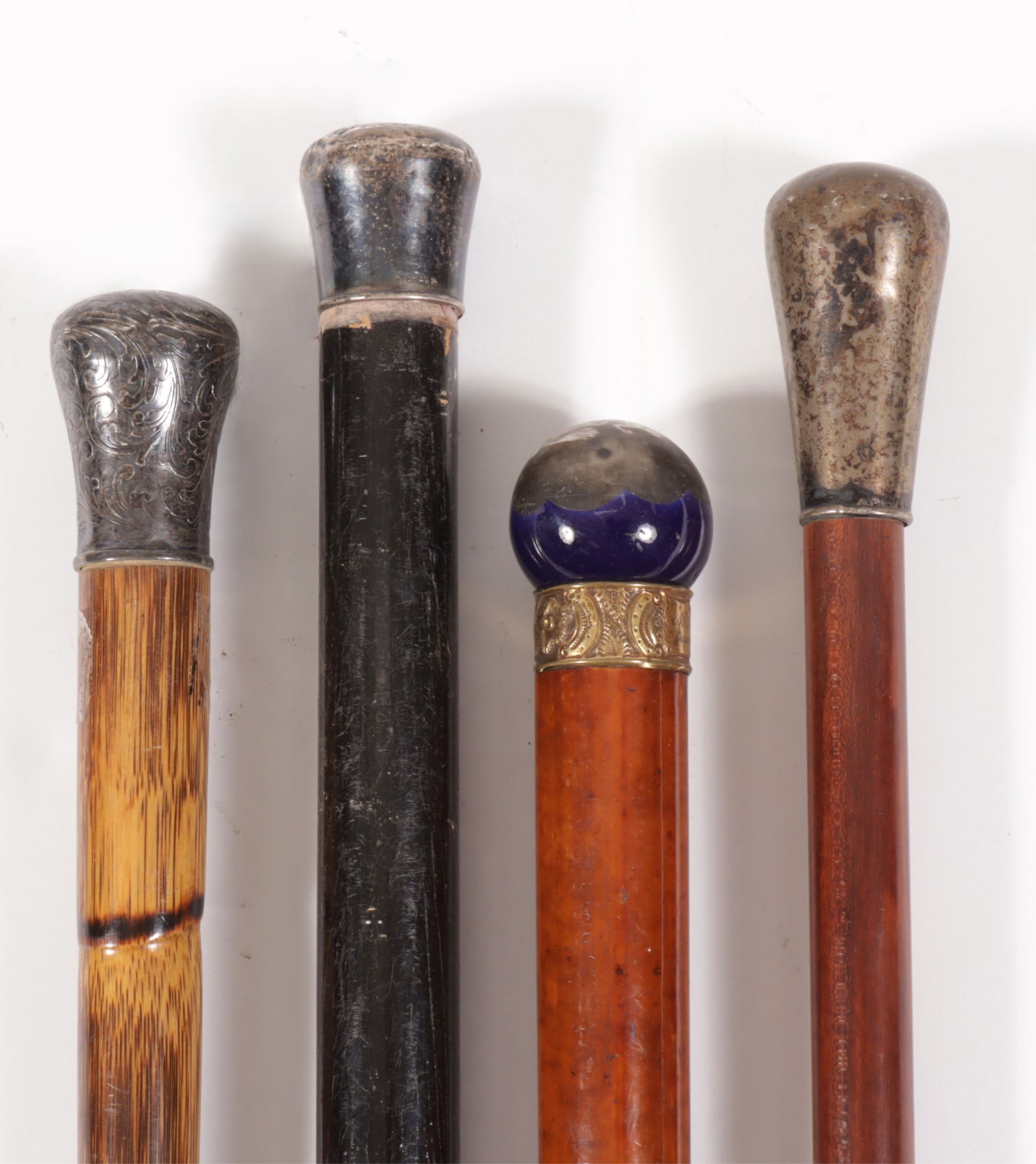 Metal Mounted Mixed Woods Walking Canes: Four Metal Mounted Mahogany Cherry & Bamboo Walking Canes Dimensions: Largest 37" L