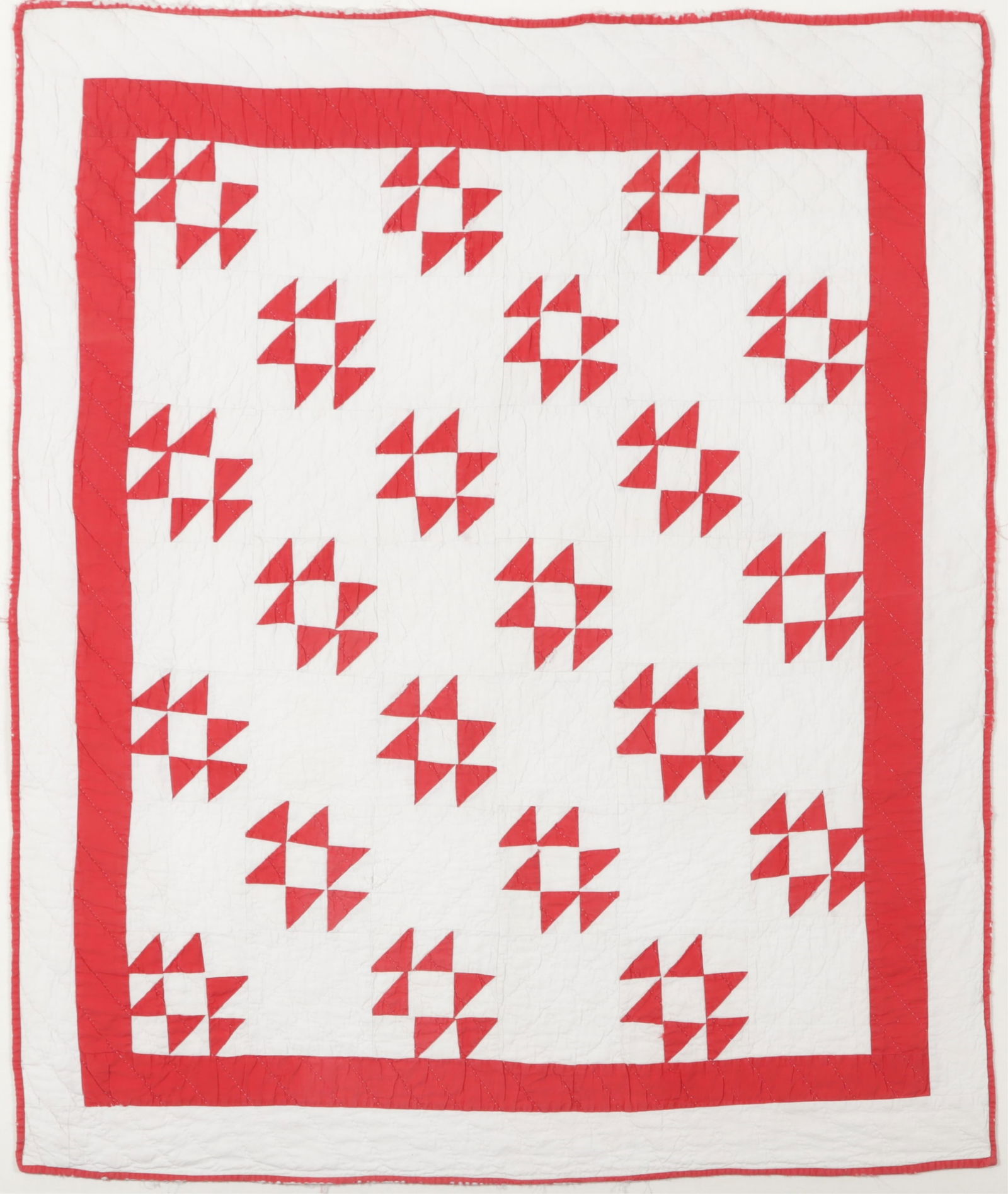 Framed Antique Child's Quilt, c 1910: A framed white and red cotton child's quilt, circa 1910, tacked to linen backing and housed in clear acrylic frame. Dimensions: Framed 43.5 x 37.5" 