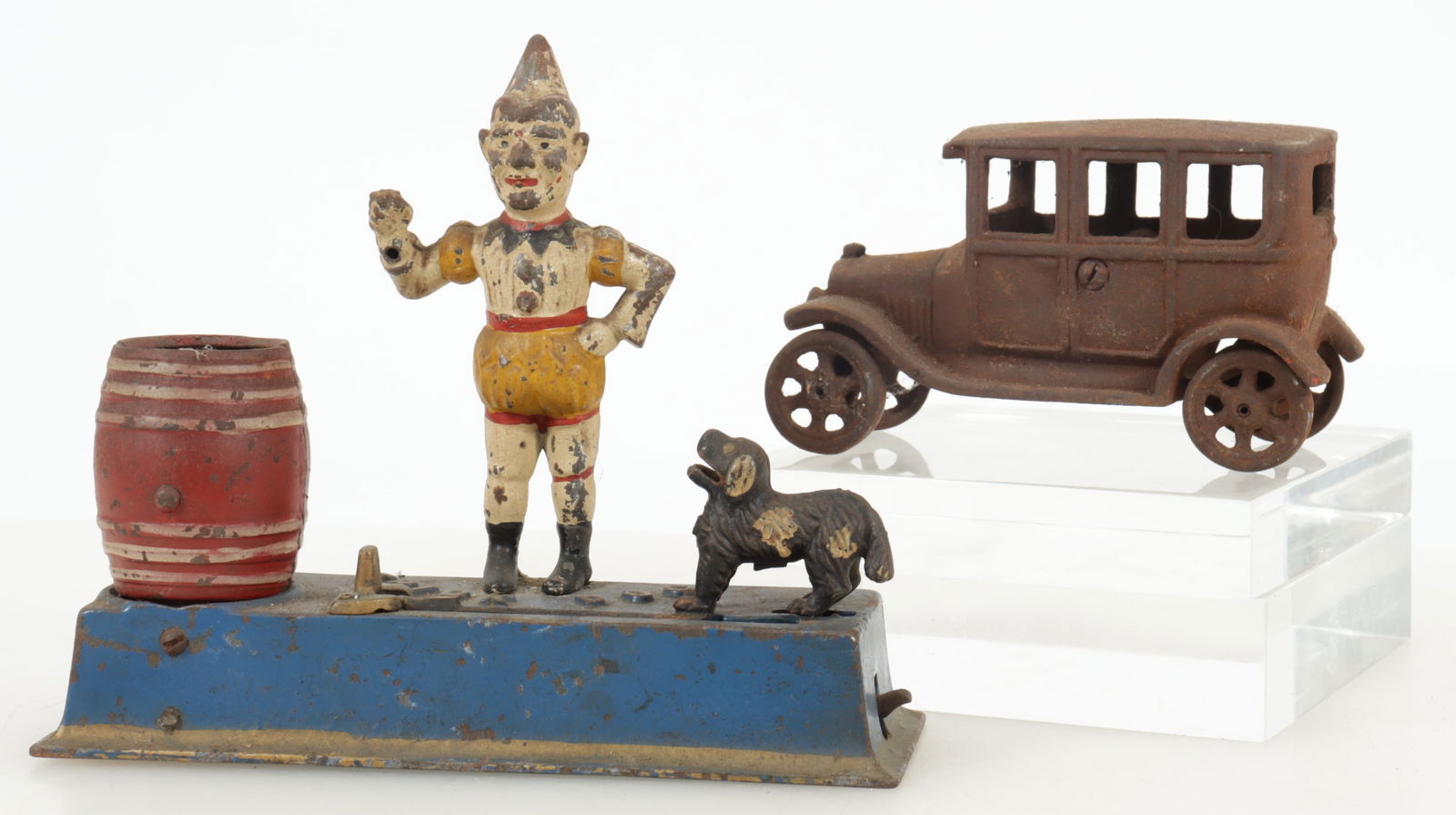 Mechanical Trick Dog Bank & Car Toy: Two cast iron toys, c.1930, includes a painted Mechanical Trick Dog Bank along with a cast iron toy car Dimensions: 7.75 H x 8.75 W x 3 D; car 3.5 H x 6.25 W x 3 D Property of a New York Antiques Deal