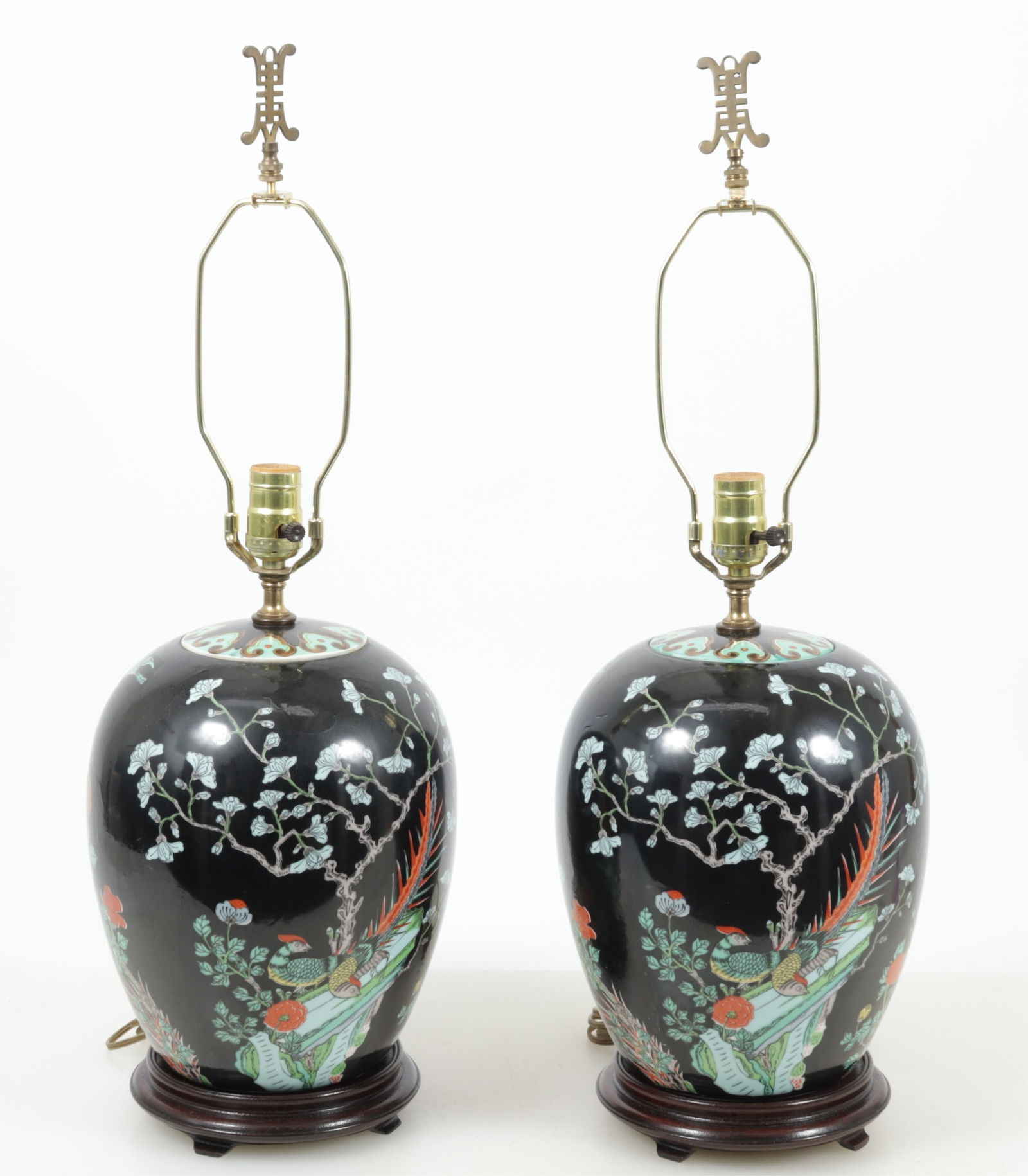 Pair of Chinese Famille Noir Lamps: A pair of vintage Chinese Famille Noir ginger jar form vases as lamps on hardwood stands. Dimensions: Vases 12 x 8". Overall 16" H to fixture. 