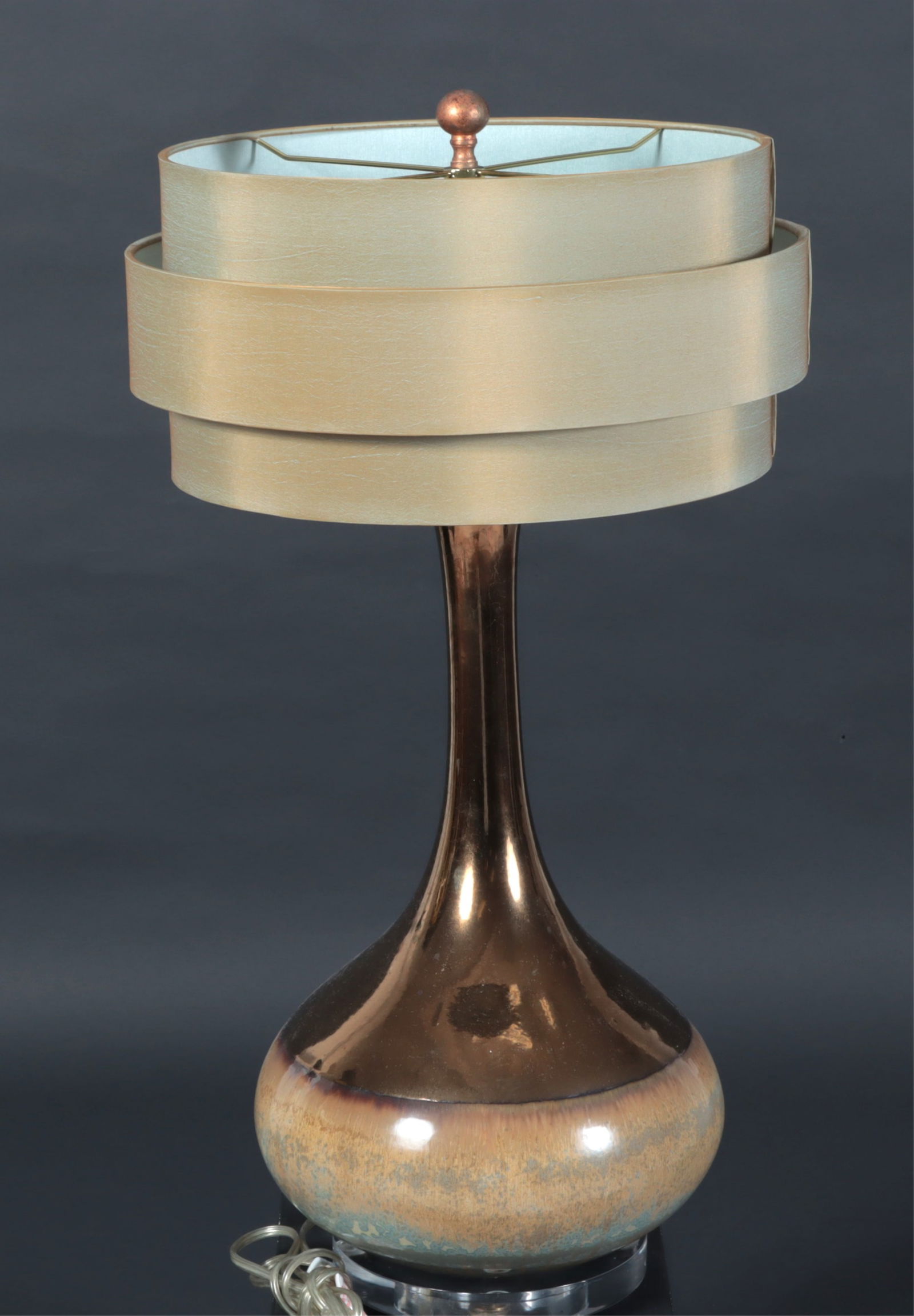 John Richard Vintage Metallic Lamp: John Richard, vintage ceramic bottle-form table lamp with metallic bronze neck and beige glazed bottom, original layered shade, on round acrylic base. Shade labeled. Dimensions: To the finial 30" H 