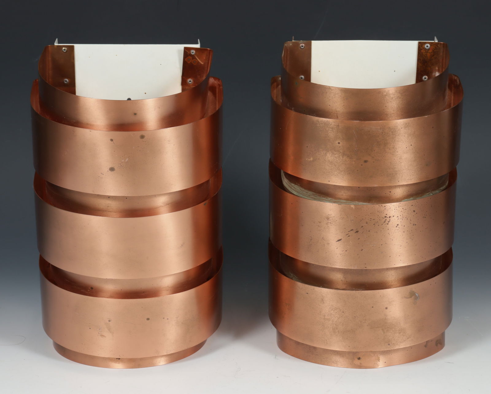 Hans-Agne Jakobsson Model V 155 Copper Wall Sconce: Pair of c.1960's Hans-Agne Jakobsson Model V 155 for Markaryd Copper Wall Sconces, label adhered en verso, F Schuko plug Dimensions: 11 1/4 x 6 3/4 x 6 1/2 From a Washington Connecticut Home