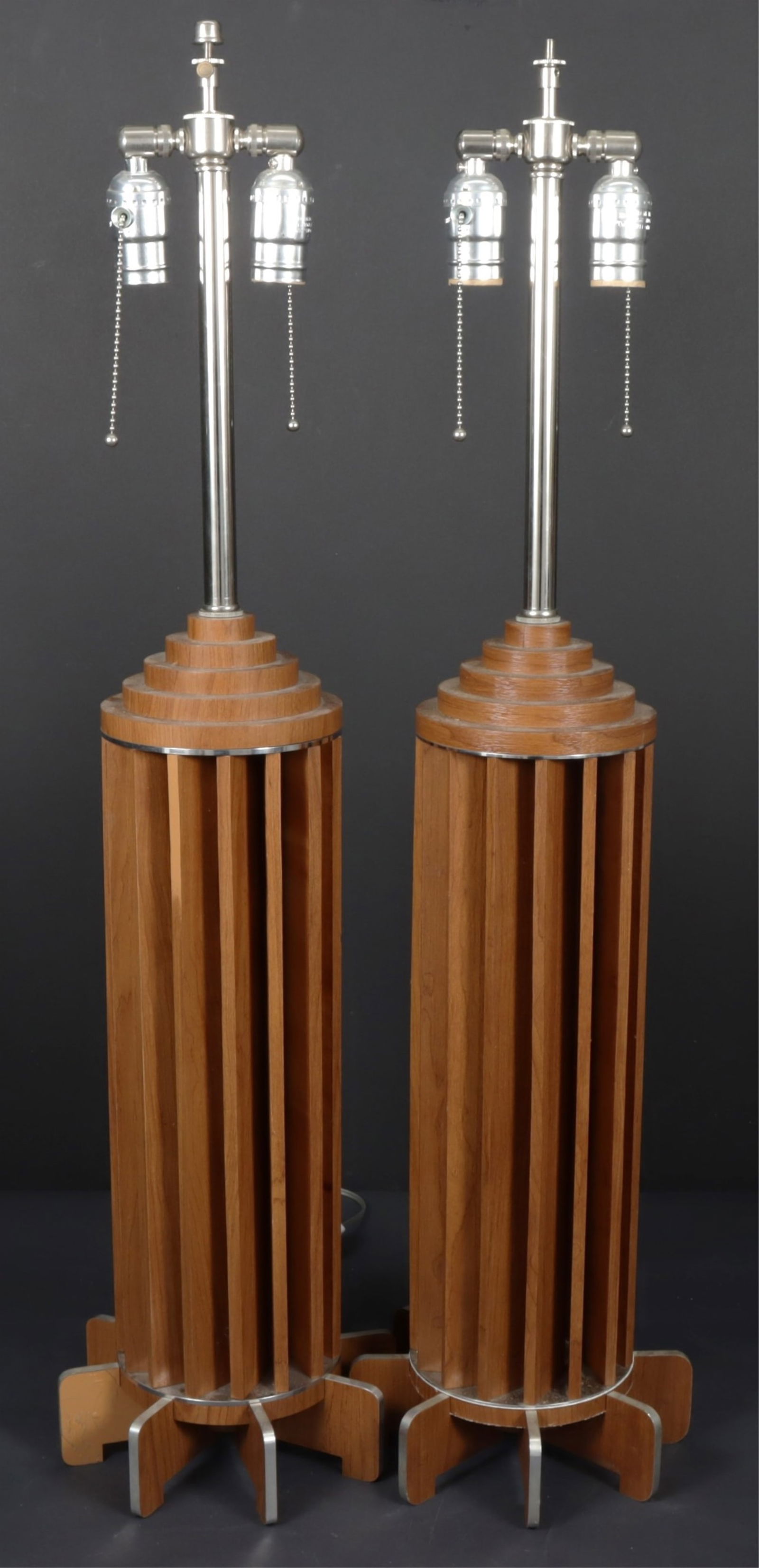Pair of Mid-century Modern Table Lamps: Manner of Mid-century modern and metal and wood columnar table lamps Dimensions: 33 1/2 x 8 5/8 Property of a New York Architect and Designer