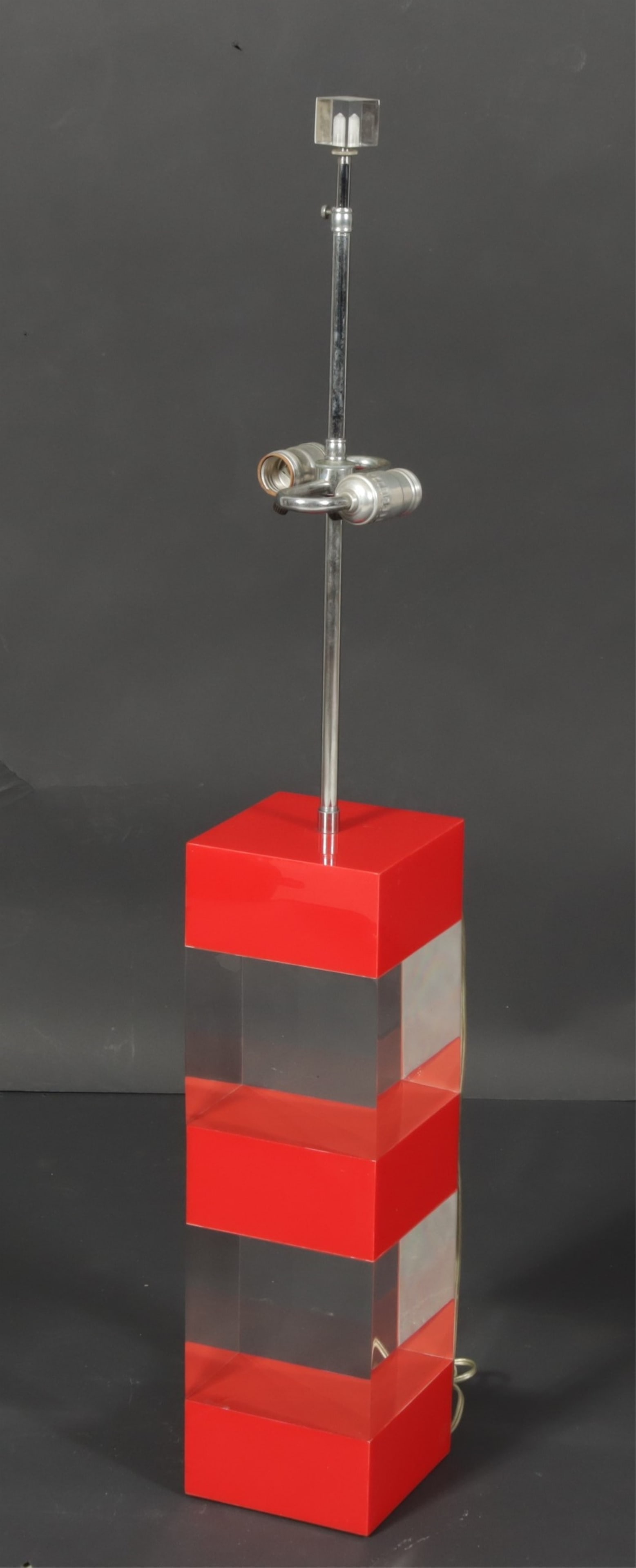 Alessandro Albrizzi Design Lucite Table Lamp: Alessandro Albrizzi Designs, c. 1999, Red and Clear Lucite Table Lamp, chrome stem, lucite cube finial Dimensions: top of finial 39"-41 1/2", (adjustable stem), 6" square Property of a New York