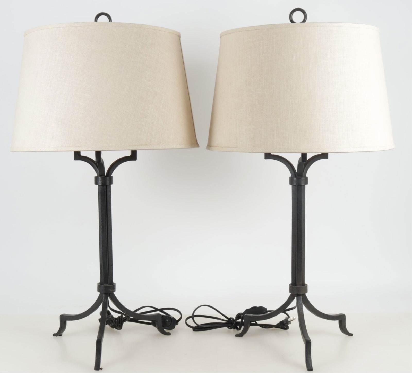 Manner of Gilbert Poillerat Table Lamps: Manner of Gilbert Poillerat table lamps, metal, linen tapered drum shades, dimmer switch Dimensions: 31 1/2 top of finial x 12 W base , shade 17 3/8 W x 10 1/2H Property of a New York Architect and